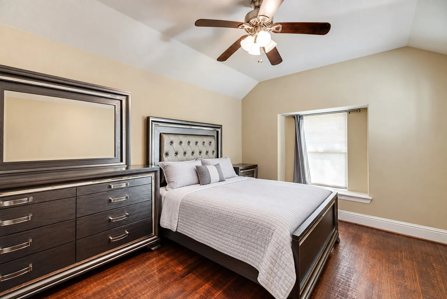 Wood-finish flooring, vaulted ceiling, and recessed window