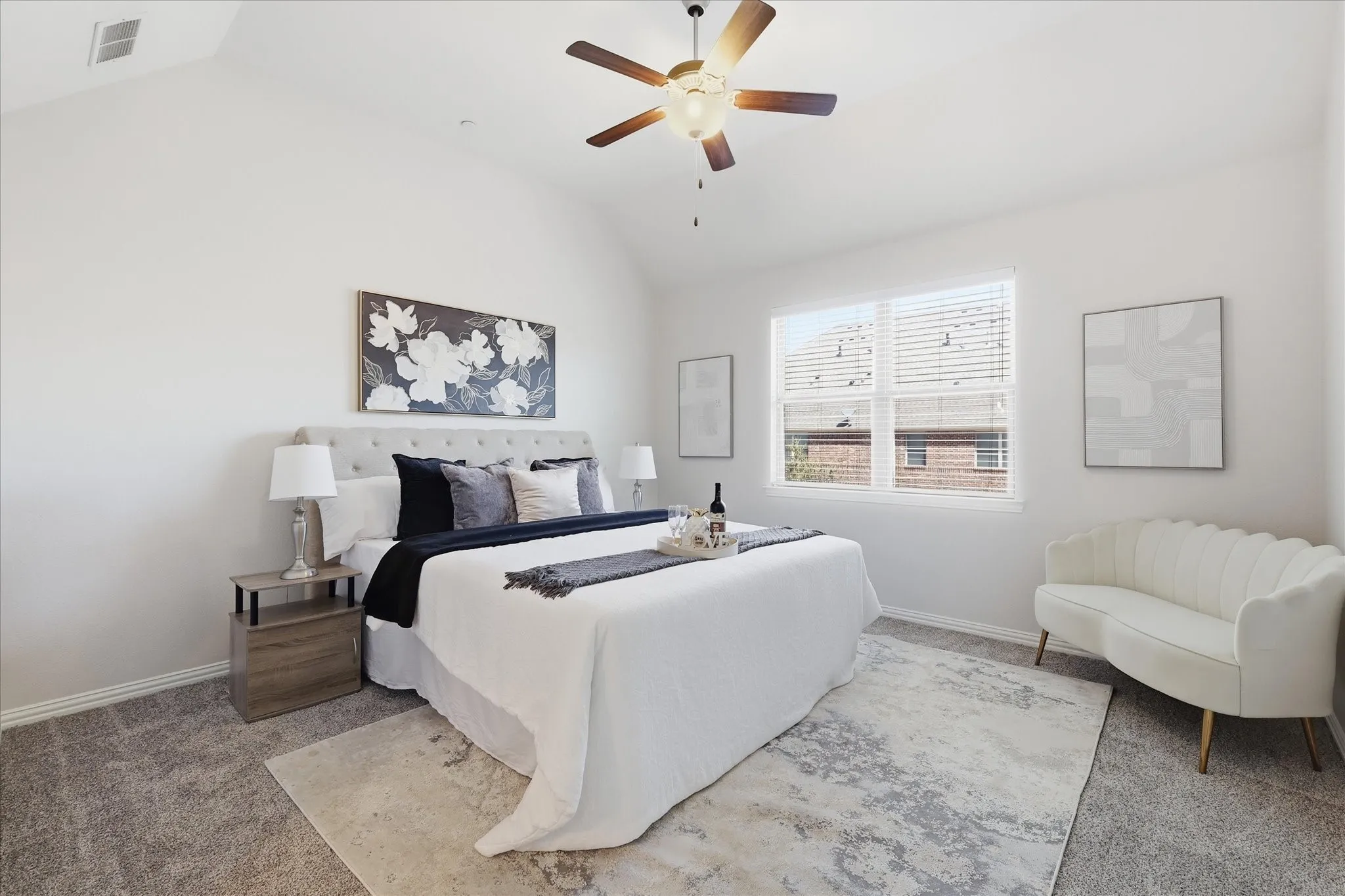 Spacious primary suite with vaulted ceiling, new plush carpet, and oversized window