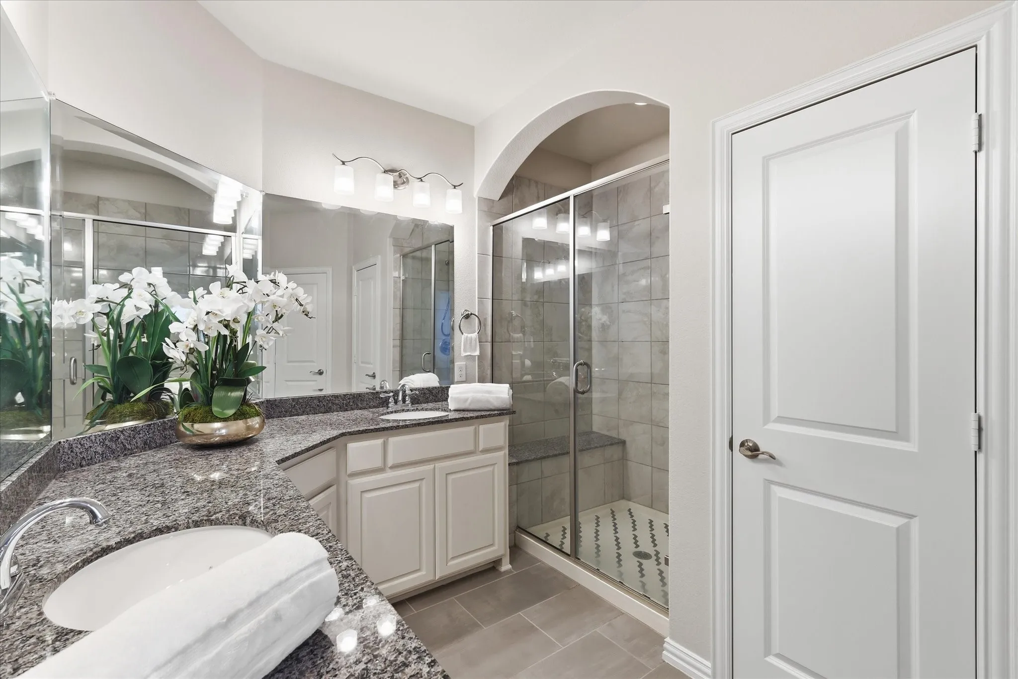 Walk-in glass shower with tiled bench seat completes the ensuite retreat