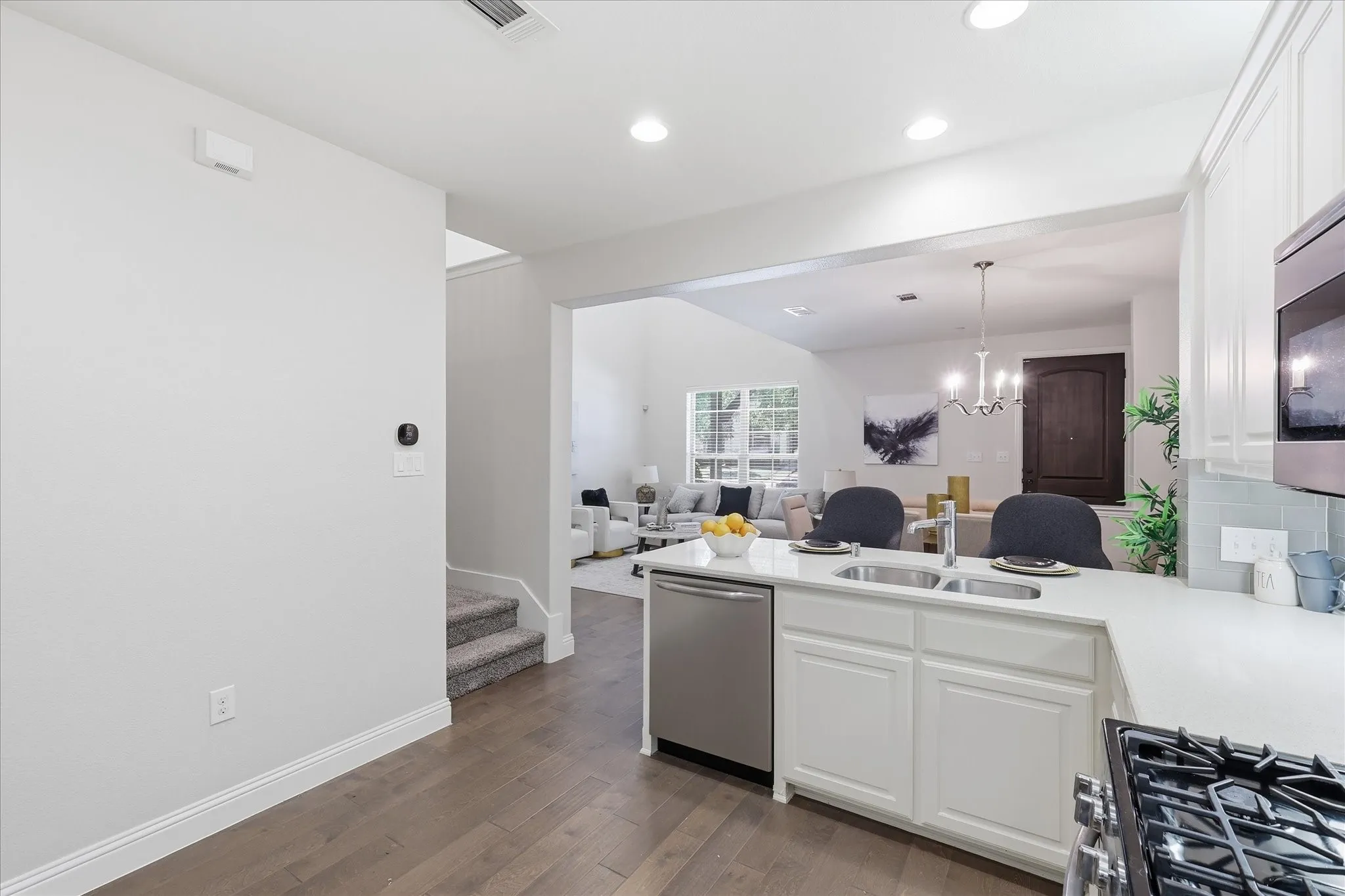 To the left is stairway with landing to half bathroom