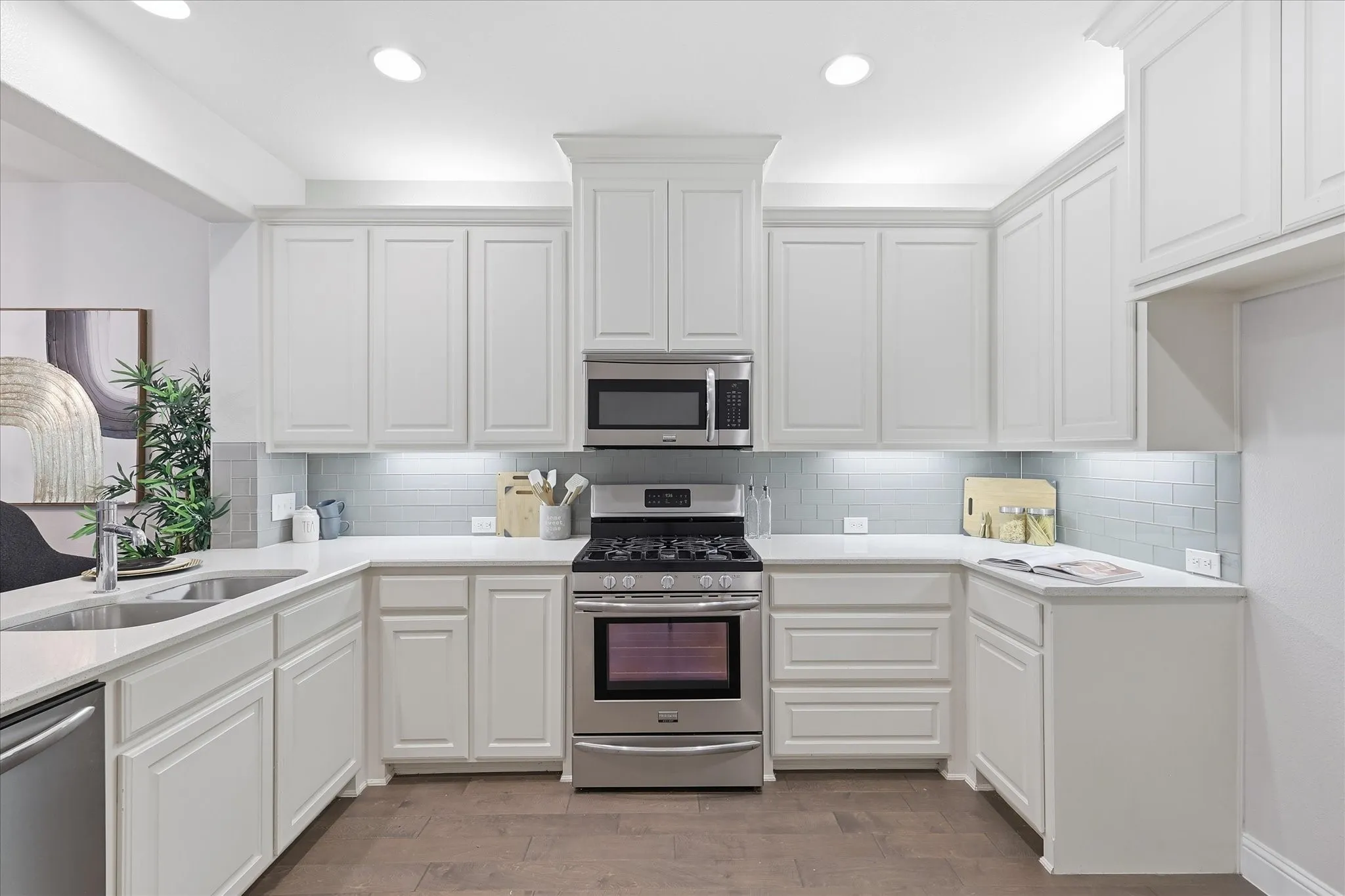 Chef ready kitchen features white cabinetry, stainless steel appliances, and a gas cooktop.