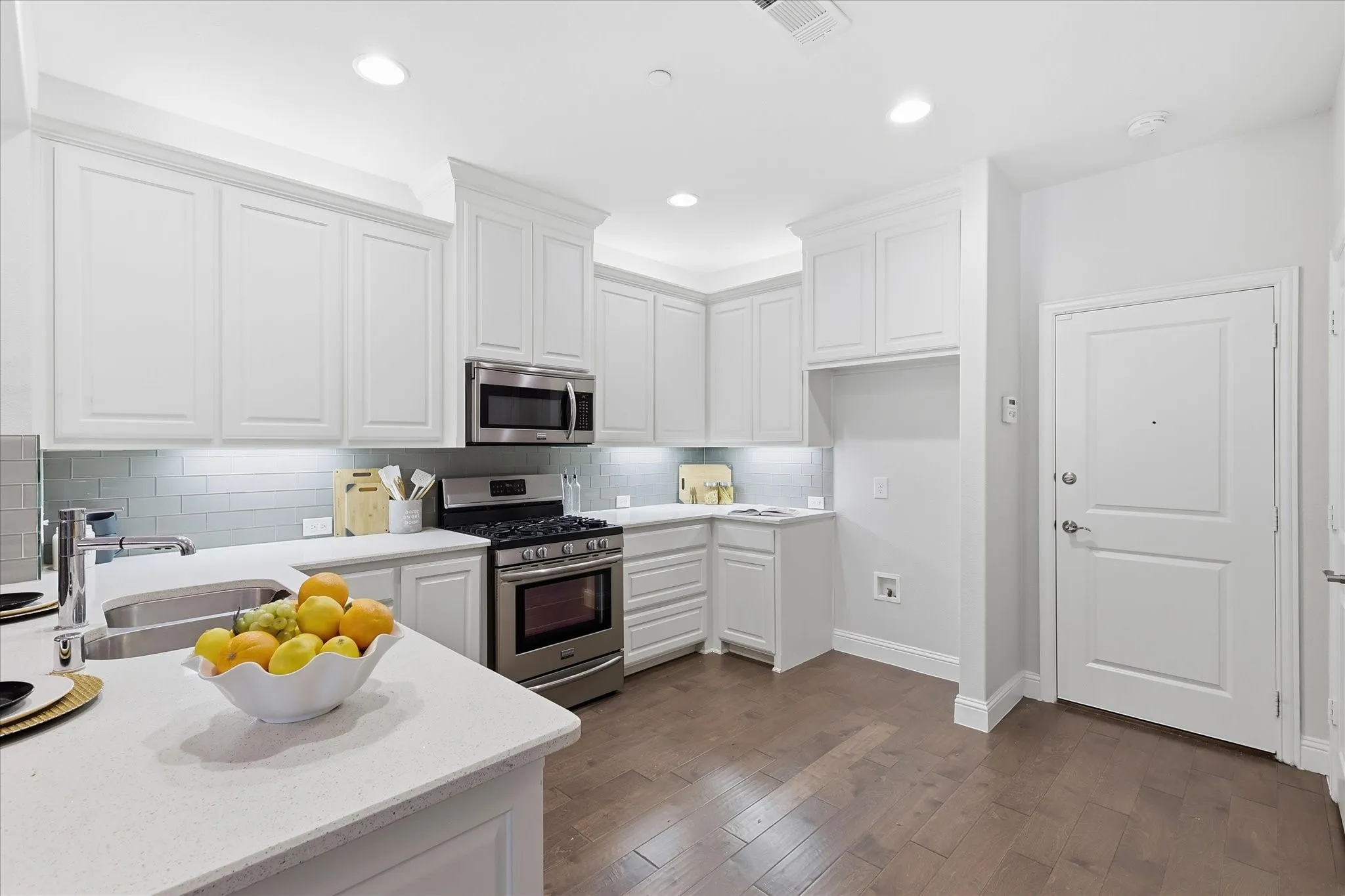 Door leading to generous 2 car garage and to the right of that large walk in pantry