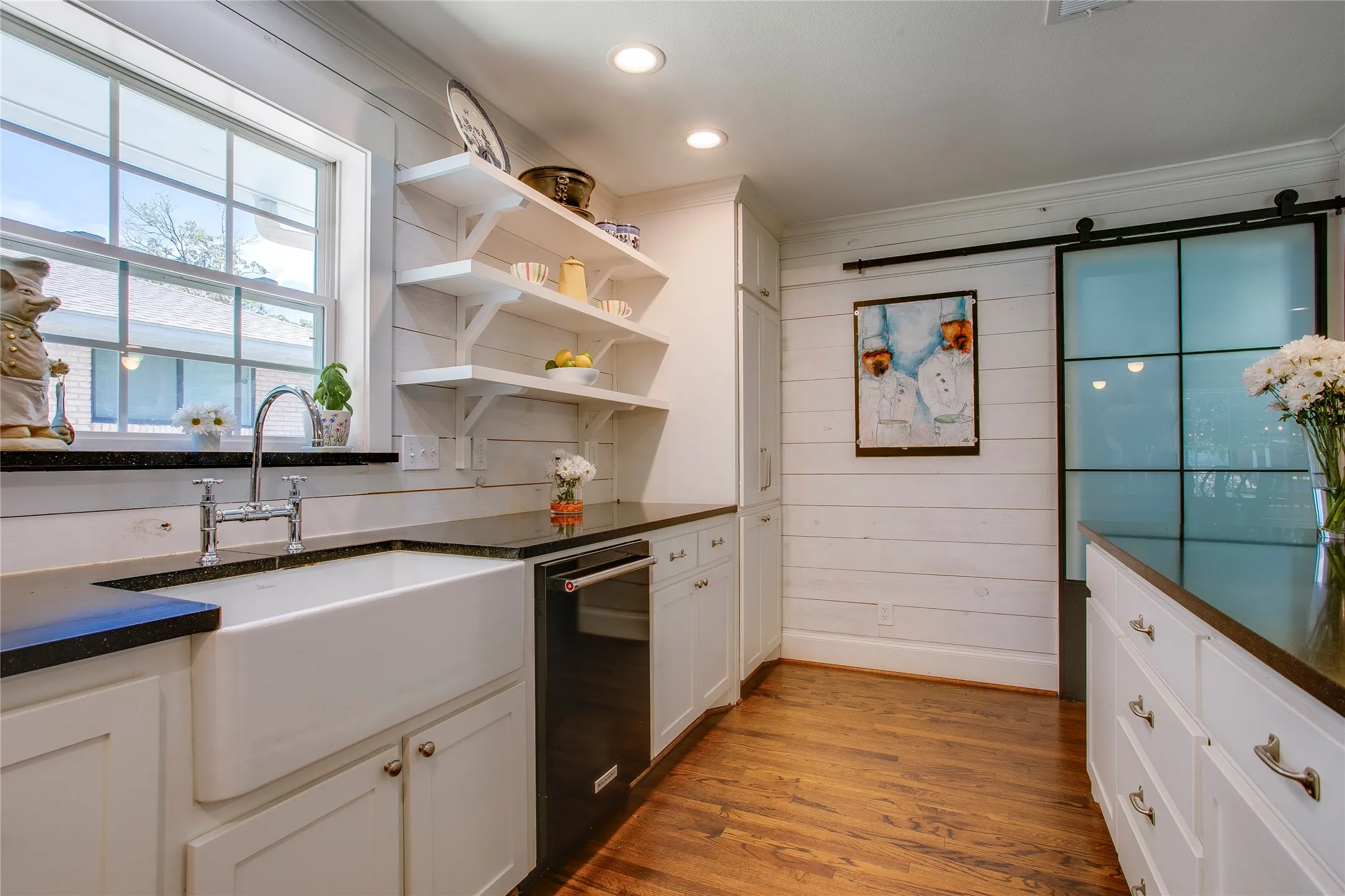 Large utility room behind the barn door also features additional storage.
