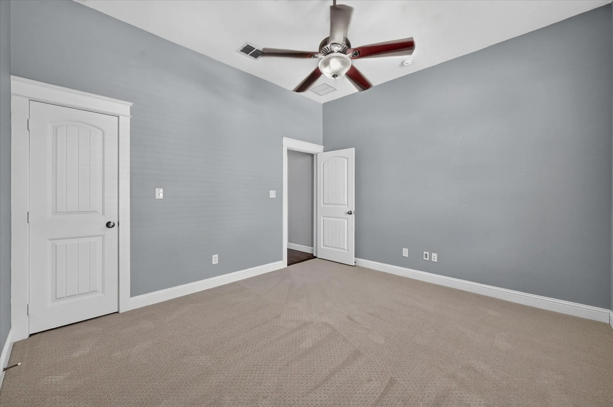 Soft gray walls, light neutral carpet, and white trim