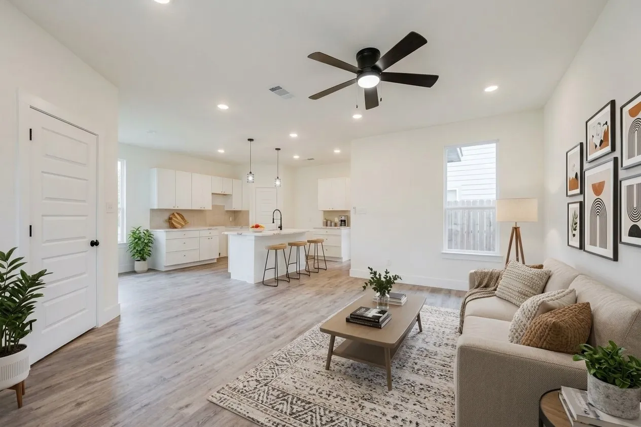 Open-concept living area with wood-finish flooring, recessed lighting, and a ceiling fan
