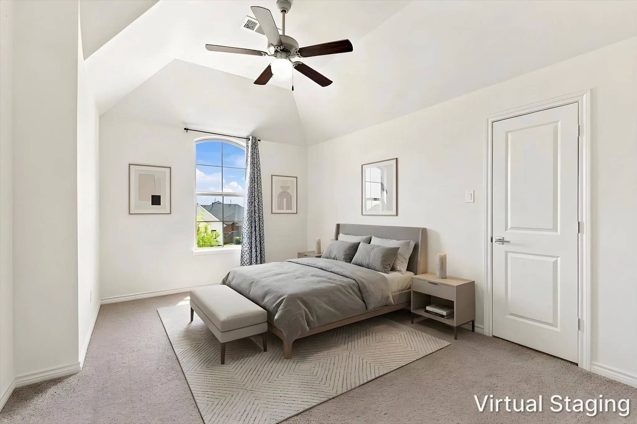 Vaulted ceiling with a ceiling fan, arched window with grid details, light-colored carpeting, and a paneled door