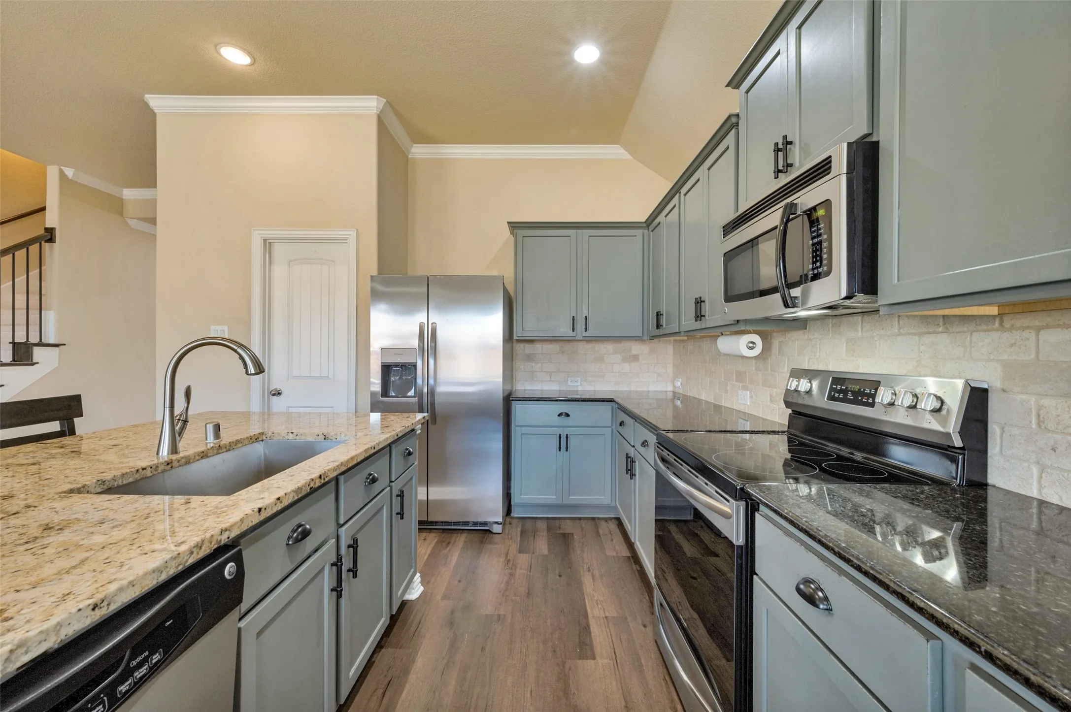 Electric range, dishwasher, disposal, microwave, refrigerator.