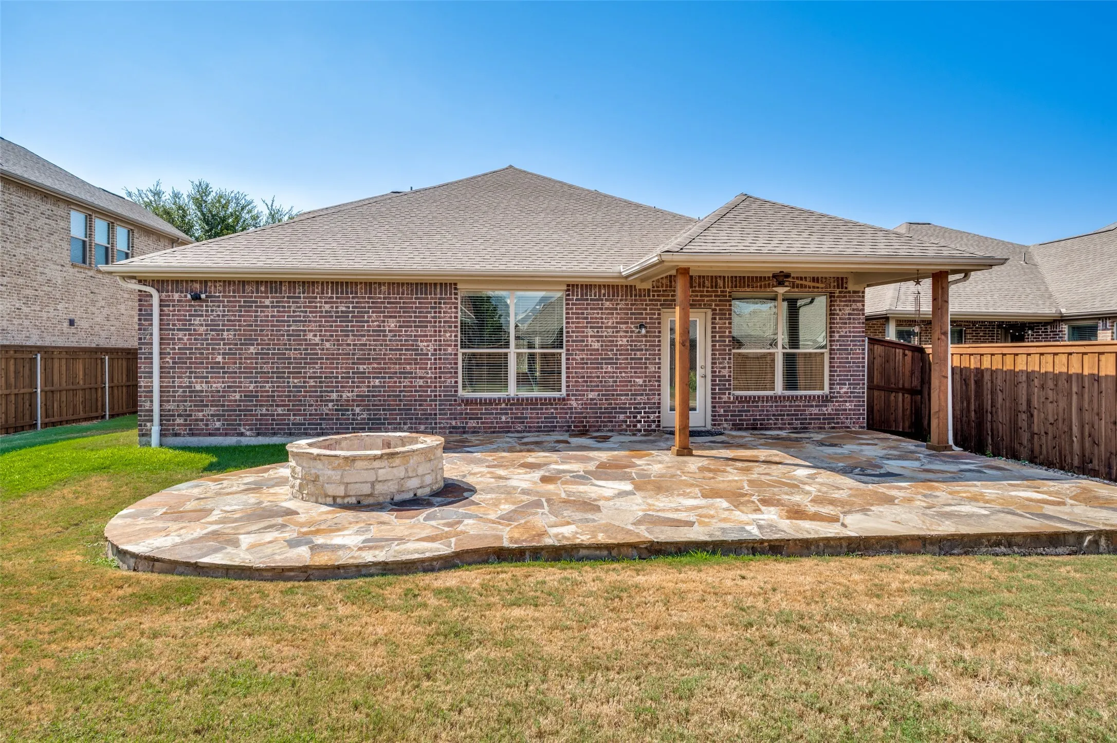Oversized backyard with extended covered patio and fire pit.