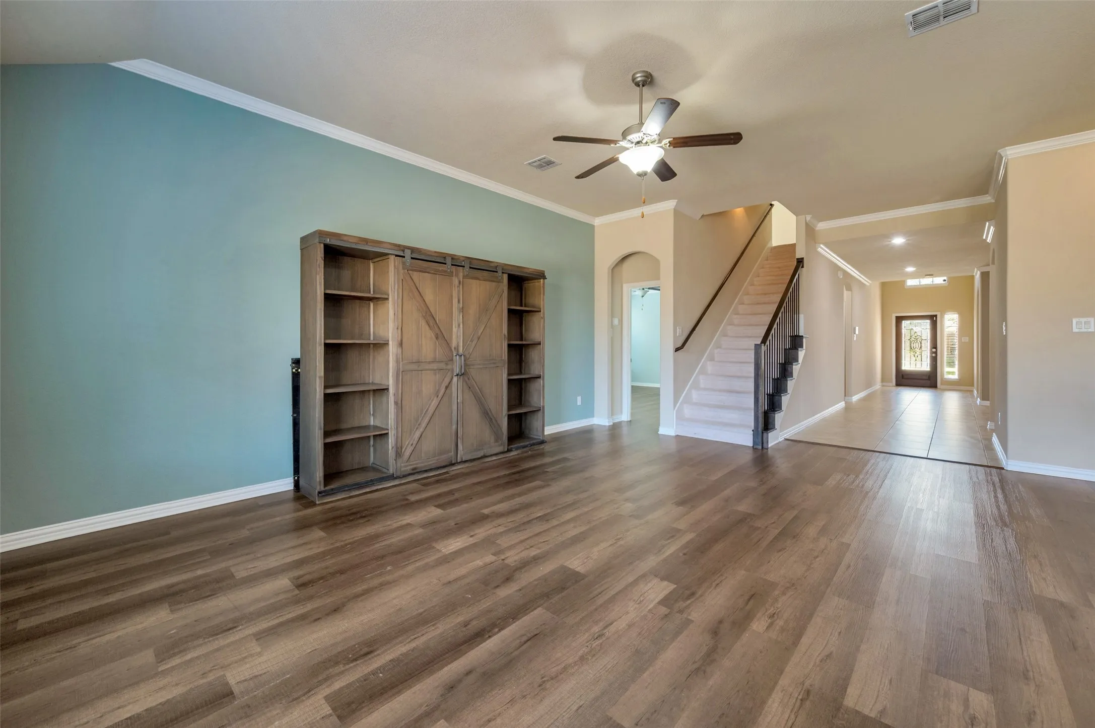 The entry leads past a guest room and dining room to the open living area.