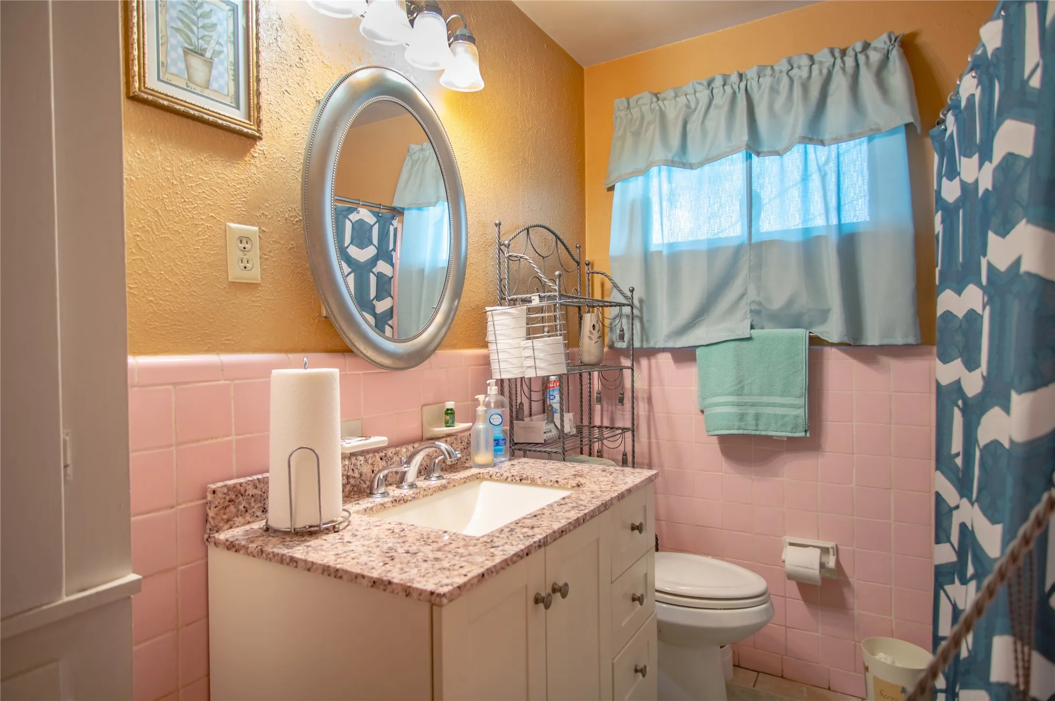 Vanity with granite-style countertop, undermount sink, and chrome faucet