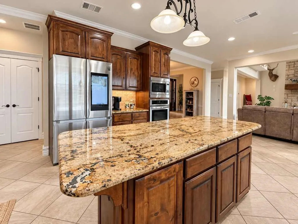 Large kitchen island offers generous prep space and casual seating.