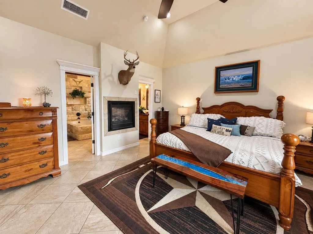 Primary bedroom with space for a sitting area and substantial furnishings.