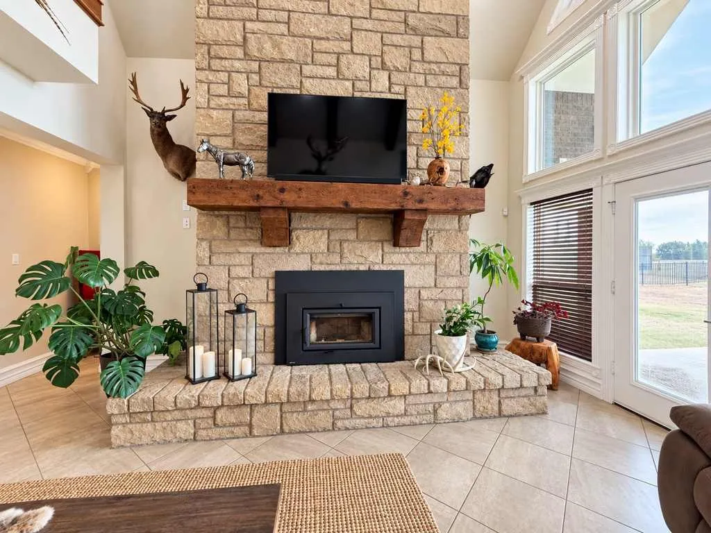 Living room with a floor-to-ceiling stone fireplace.
