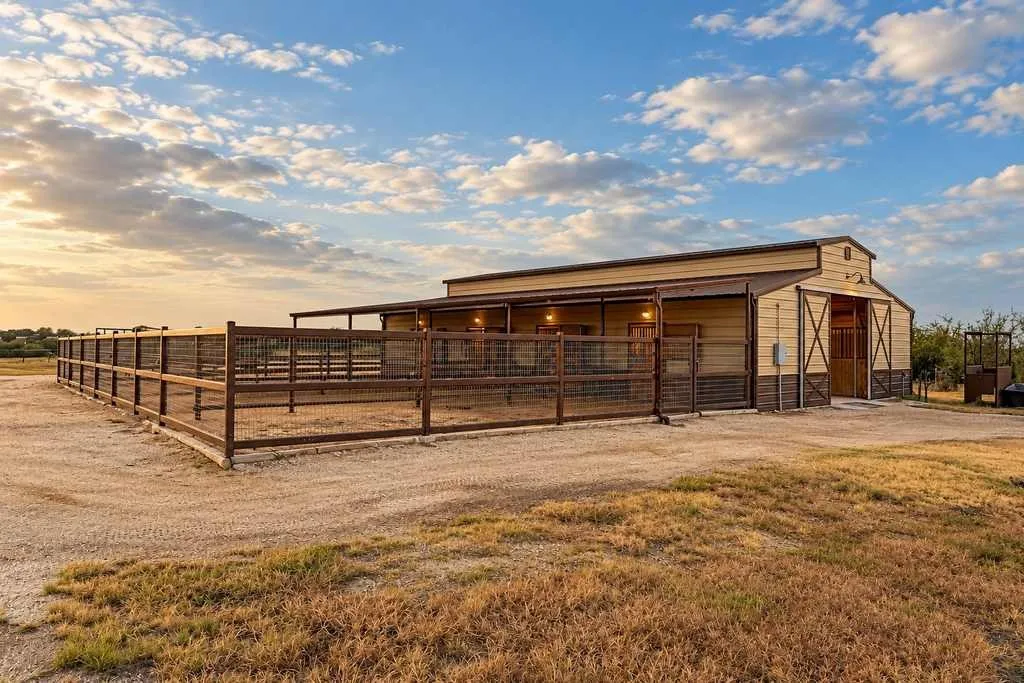 Horse barn with fenced turnout space and room for daily livestock care.
