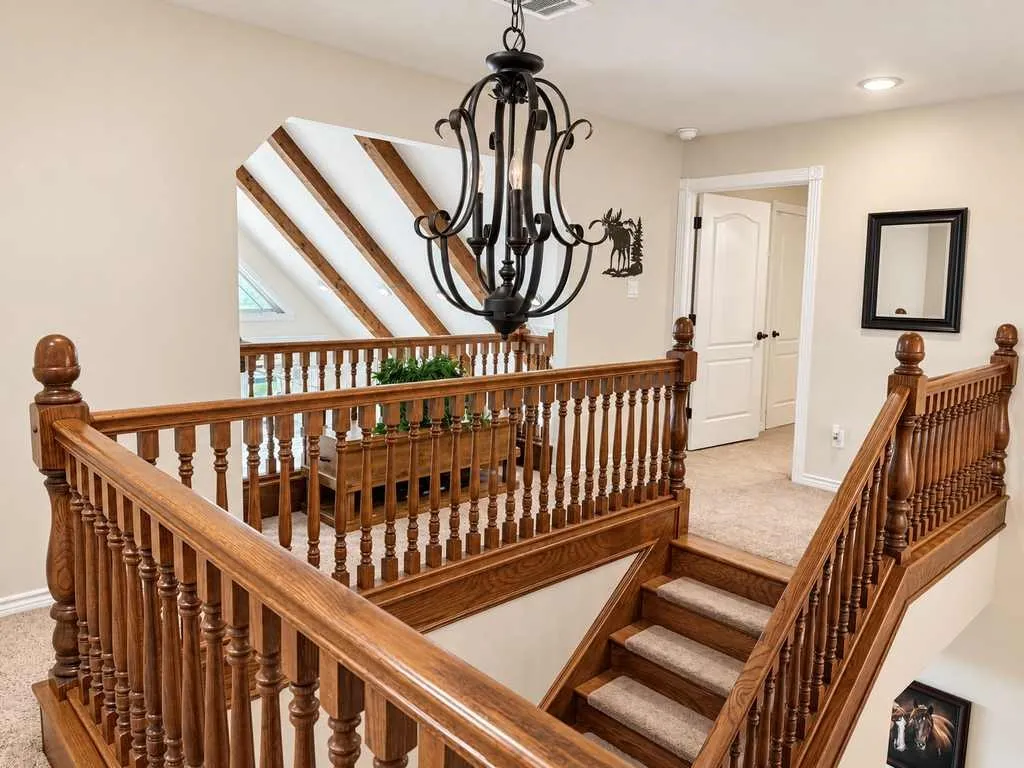 Wood staircase and open landing connect the home’s two levels.