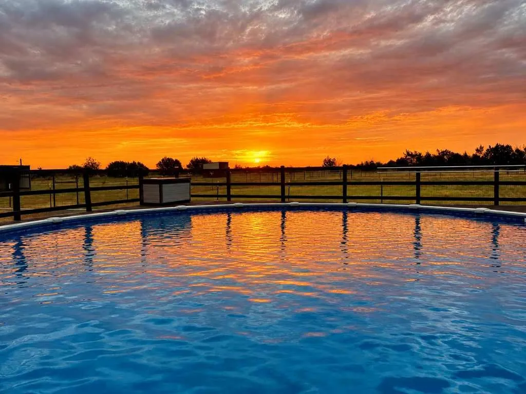 Sunset views across the pool and surrounding countryside.