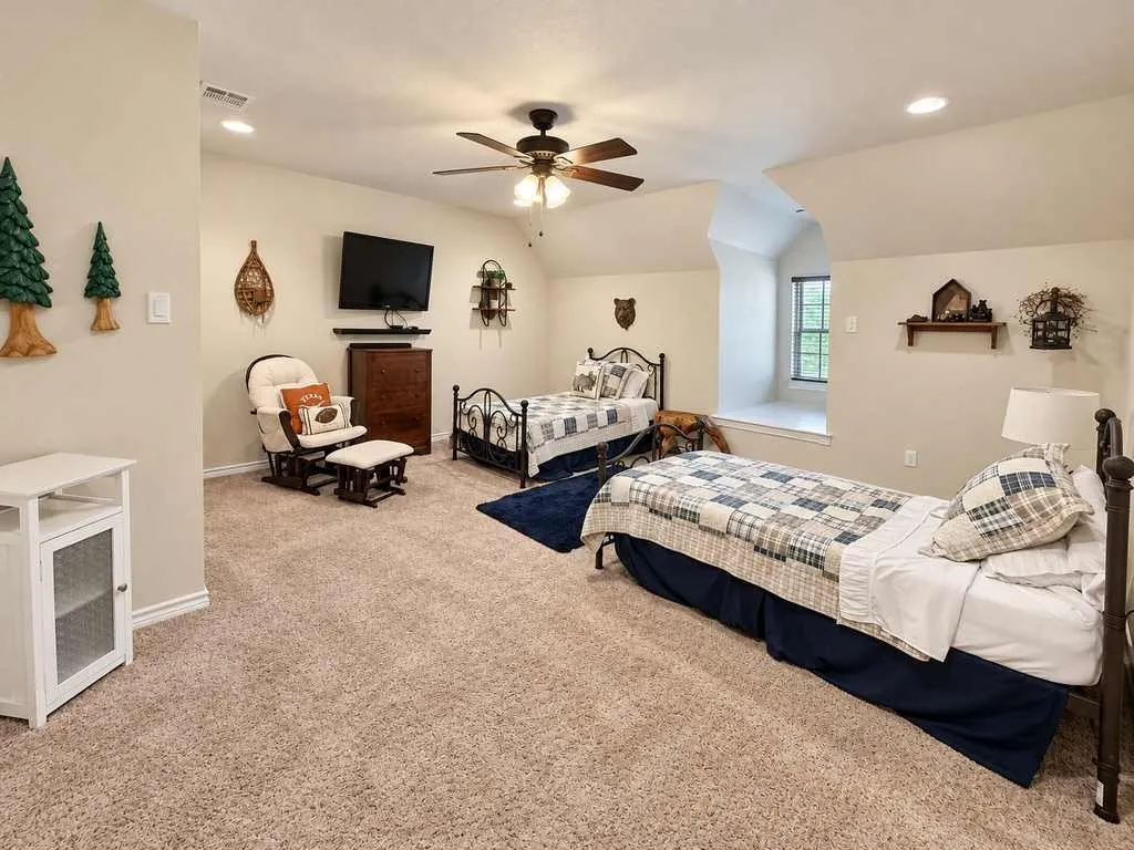 Spacious upstairs bonus room offers flexible space for recreation or guests.