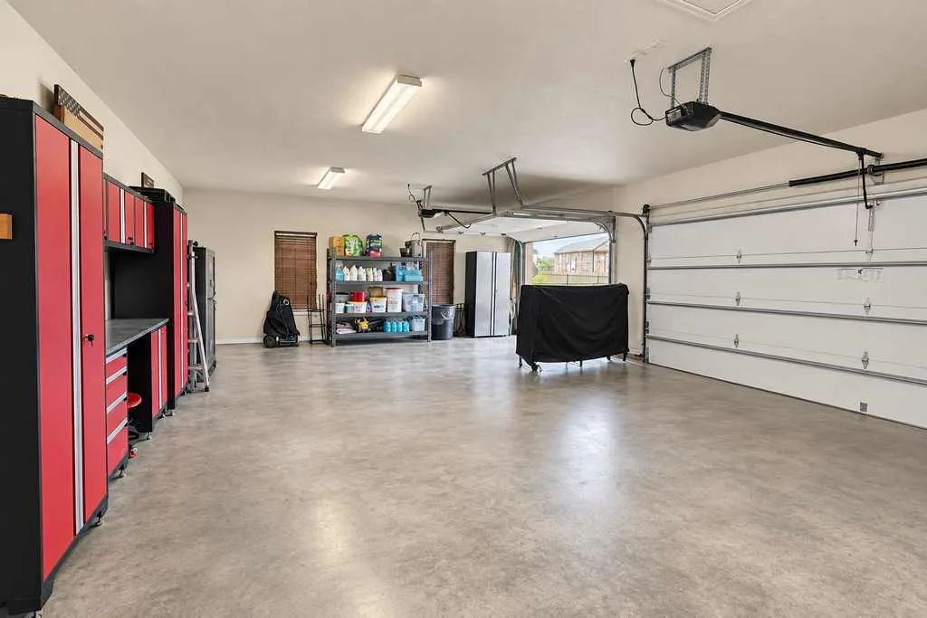 Garage interior with an overhead door and open floor space.