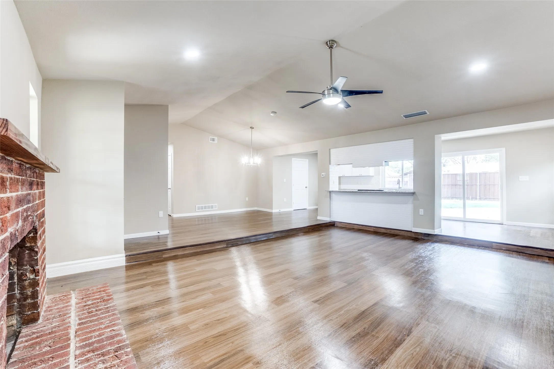 Brick fireplace with wood mantel