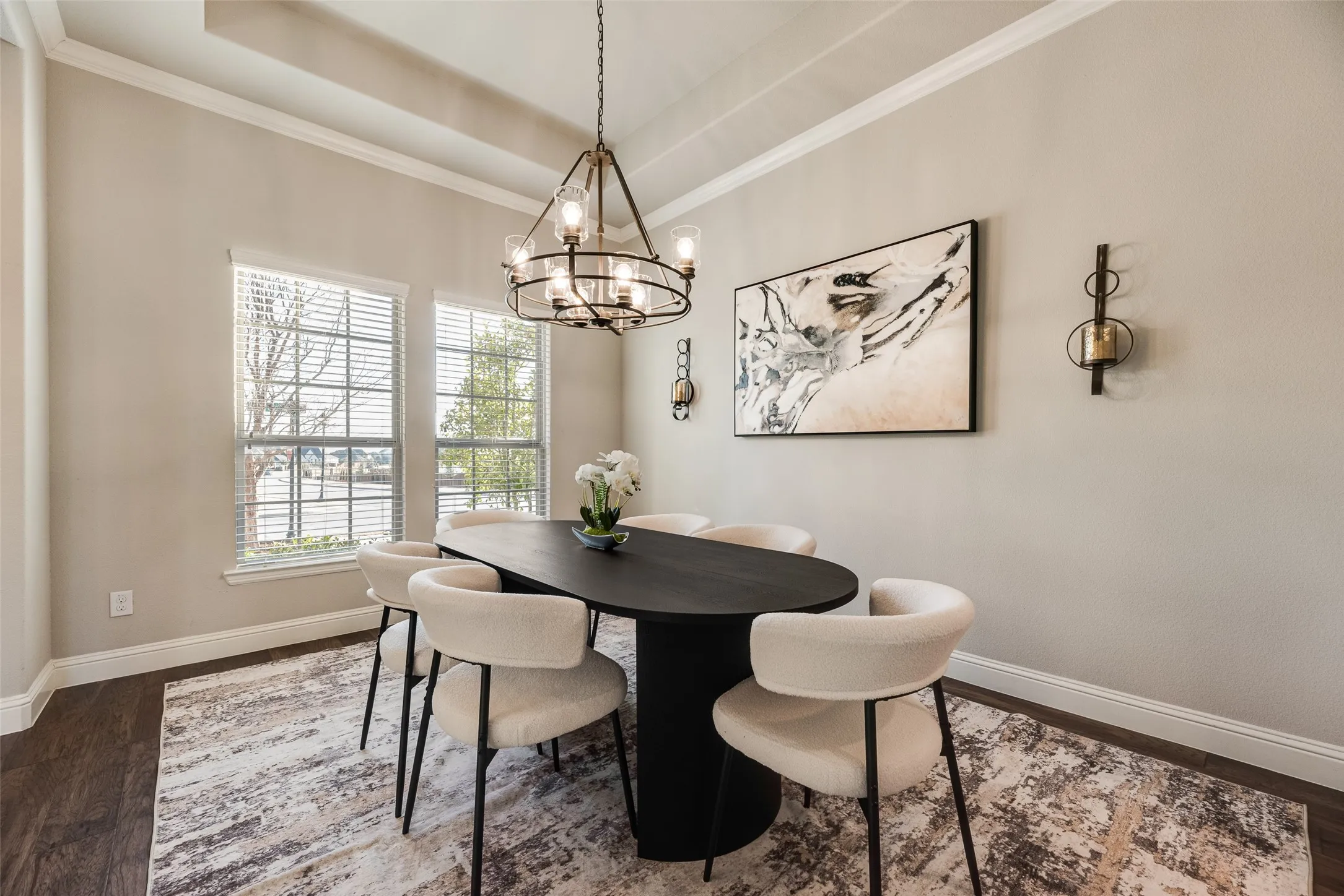 Tray ceiling with crown molding, wood-finish flooring, and two large windows