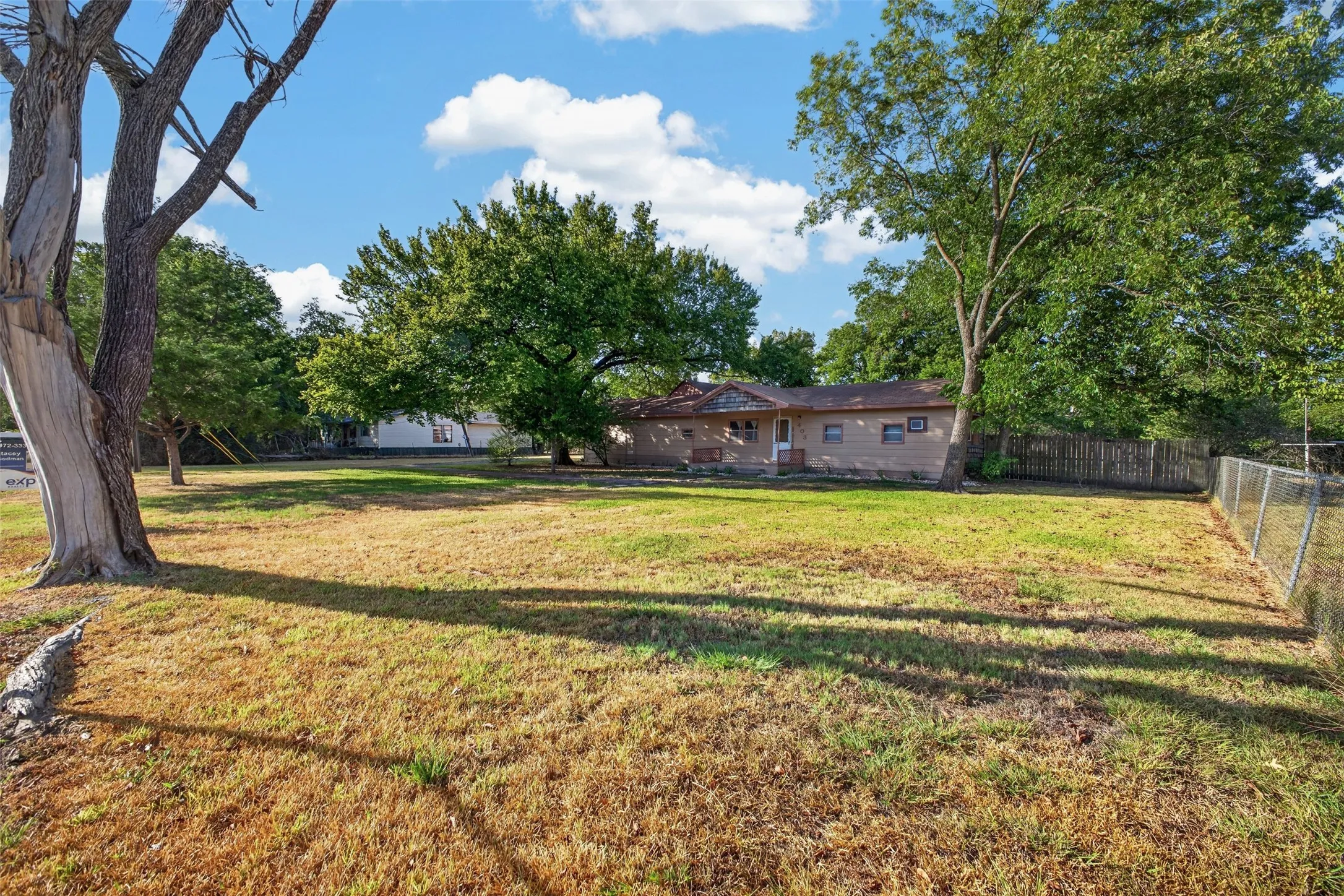 Expansive lawn framed by mature trees
