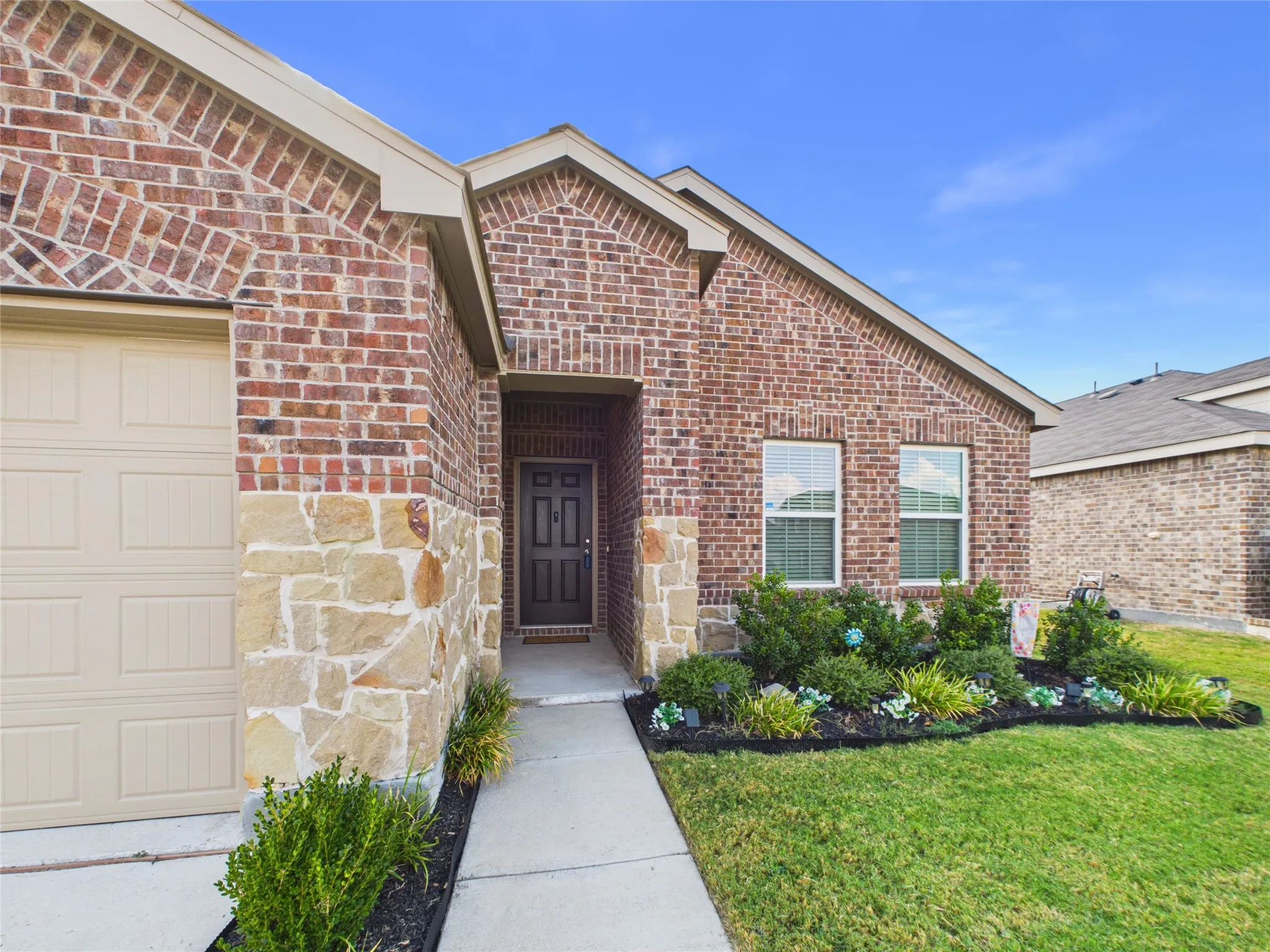 Landscaped front yard and nice walk up to the front door.