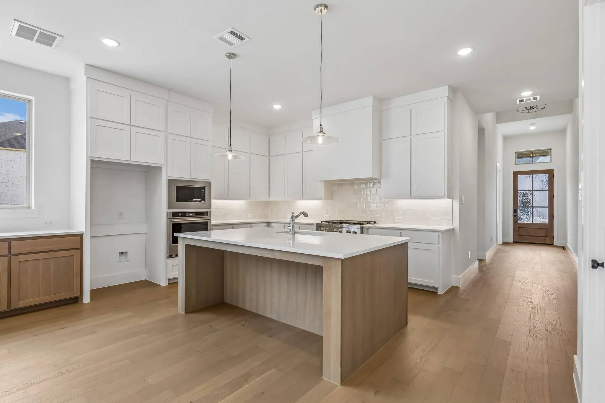 Featuring high ceilings with dual stacked cabinetry and ample prep space, this dream kitchen has it all!