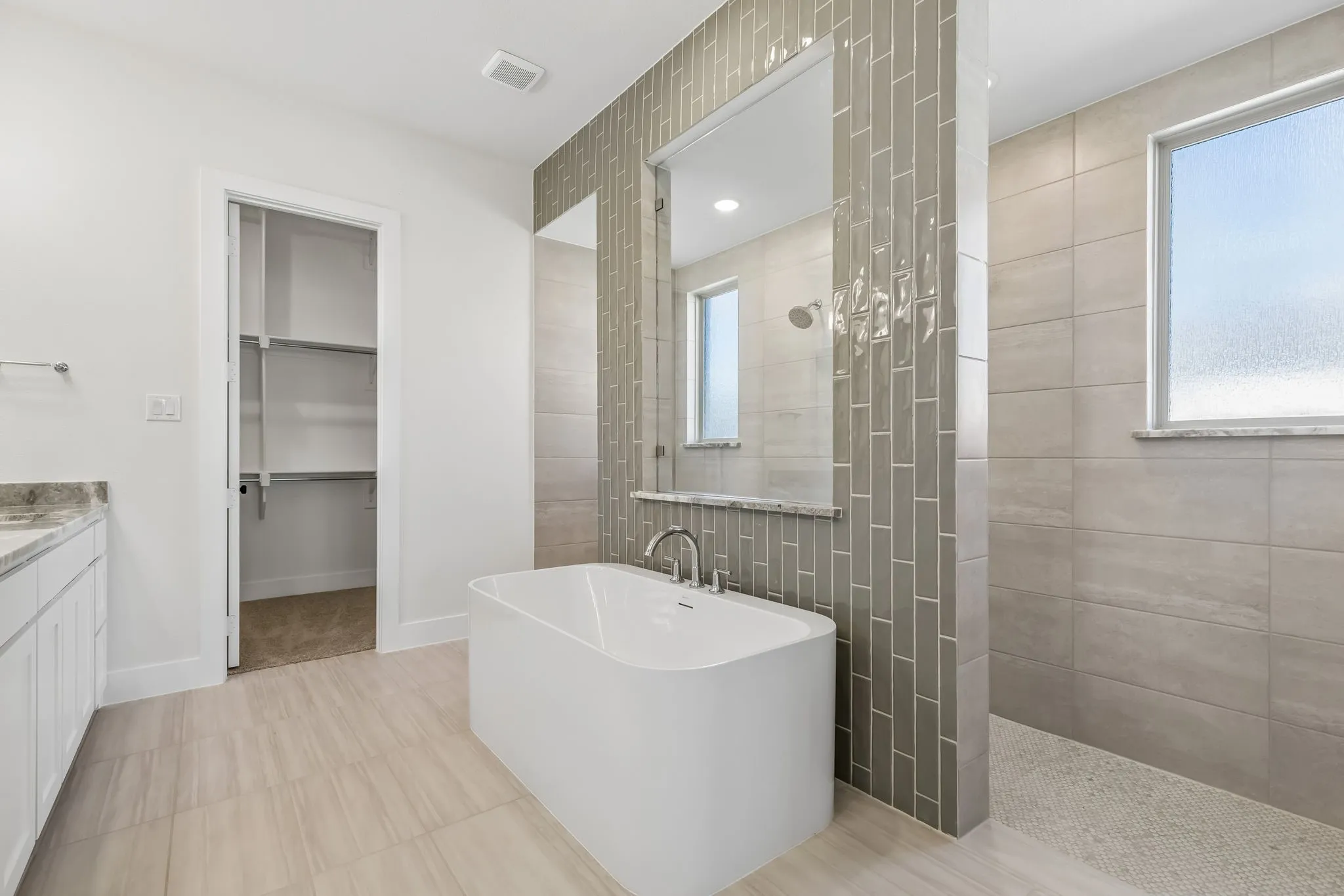 Our Justin plan features our signature bath with walk through shower and free standing tub!
