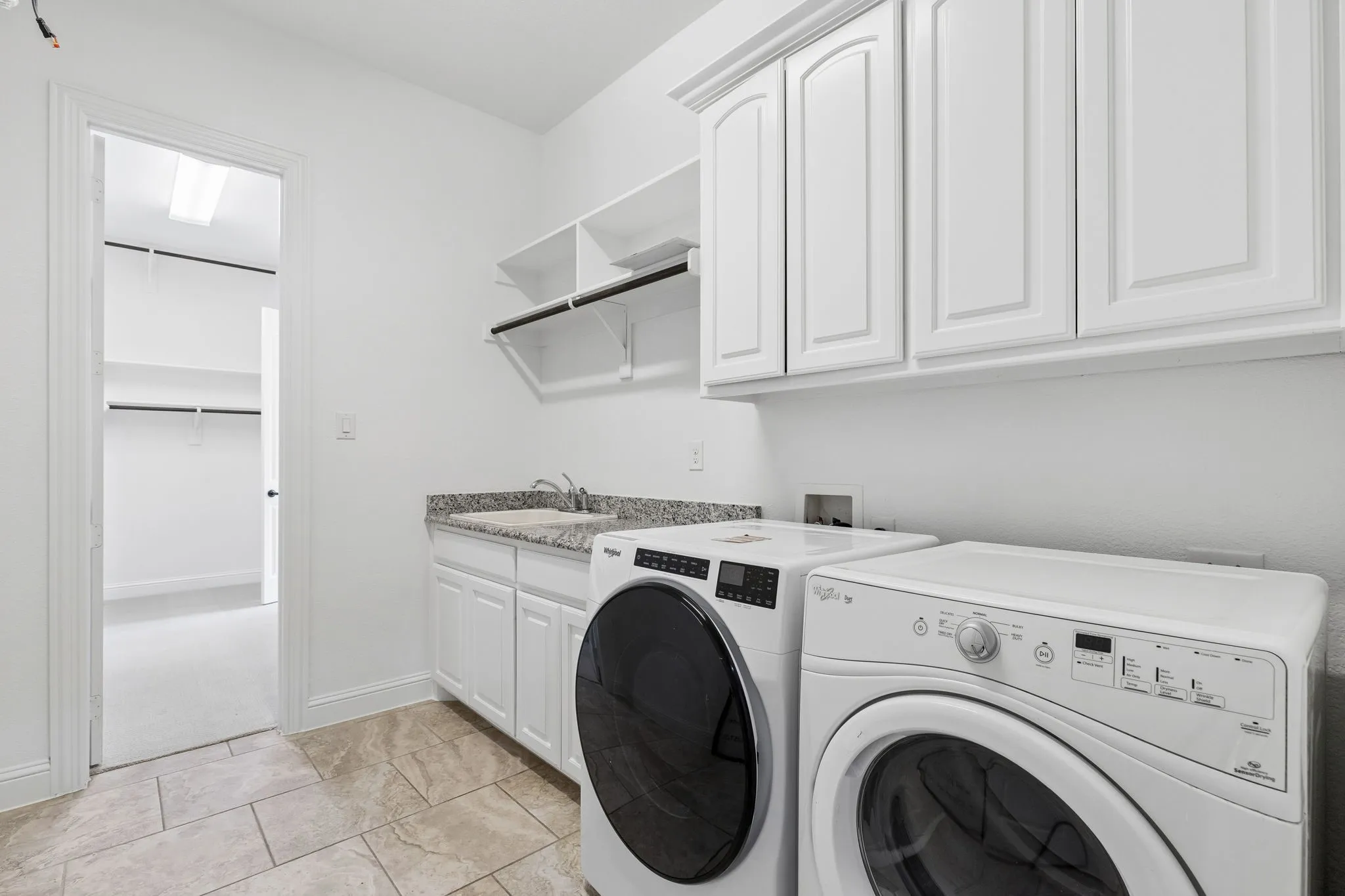 Primary closet connects to the laundry room