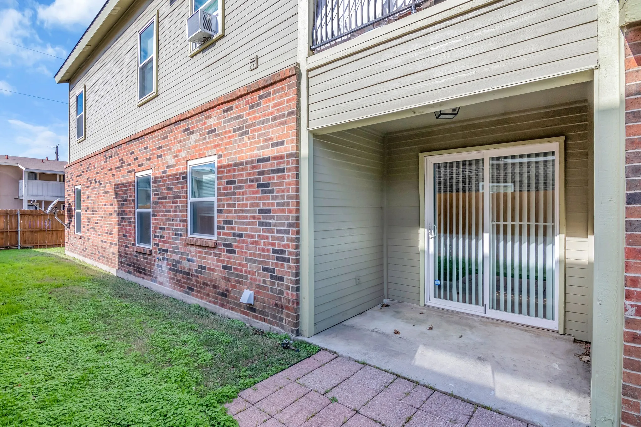Unit A - Brick and siding exterior with multiple windows