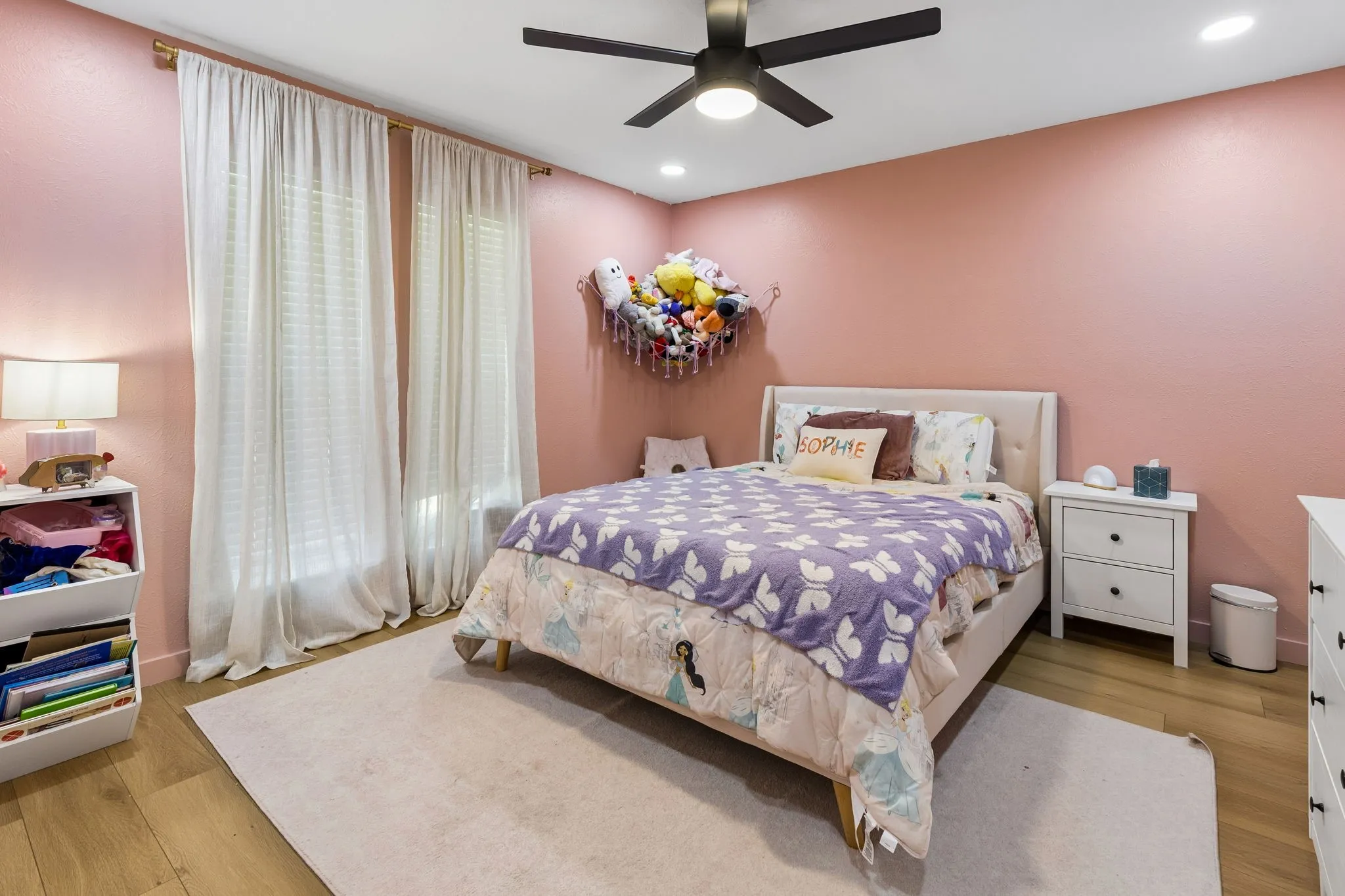 Recessed lighting, wood-finish flooring, ceiling fan, and window treatments