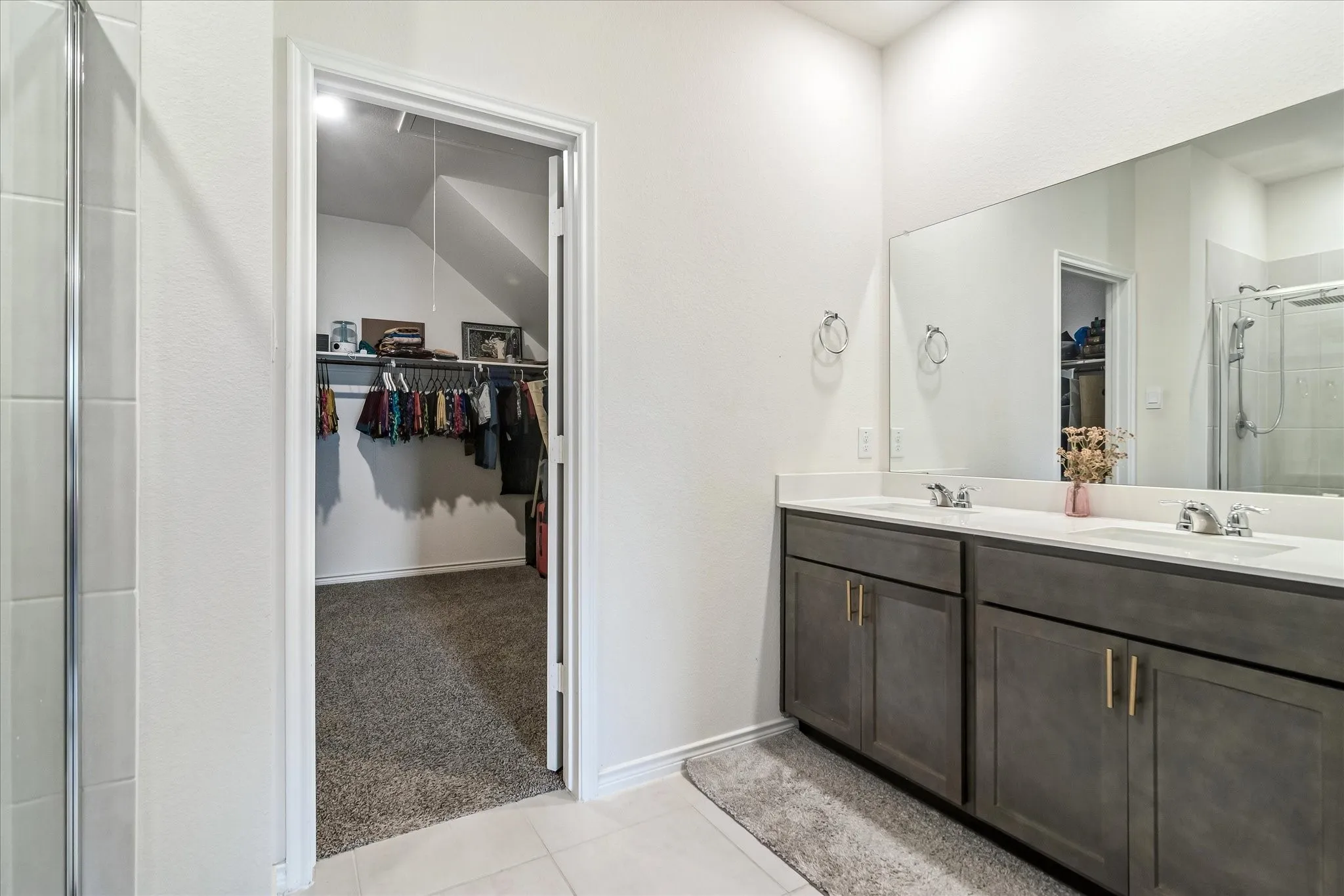 Dual vanity with white countertops, undermount sinks, and gray cabinetry