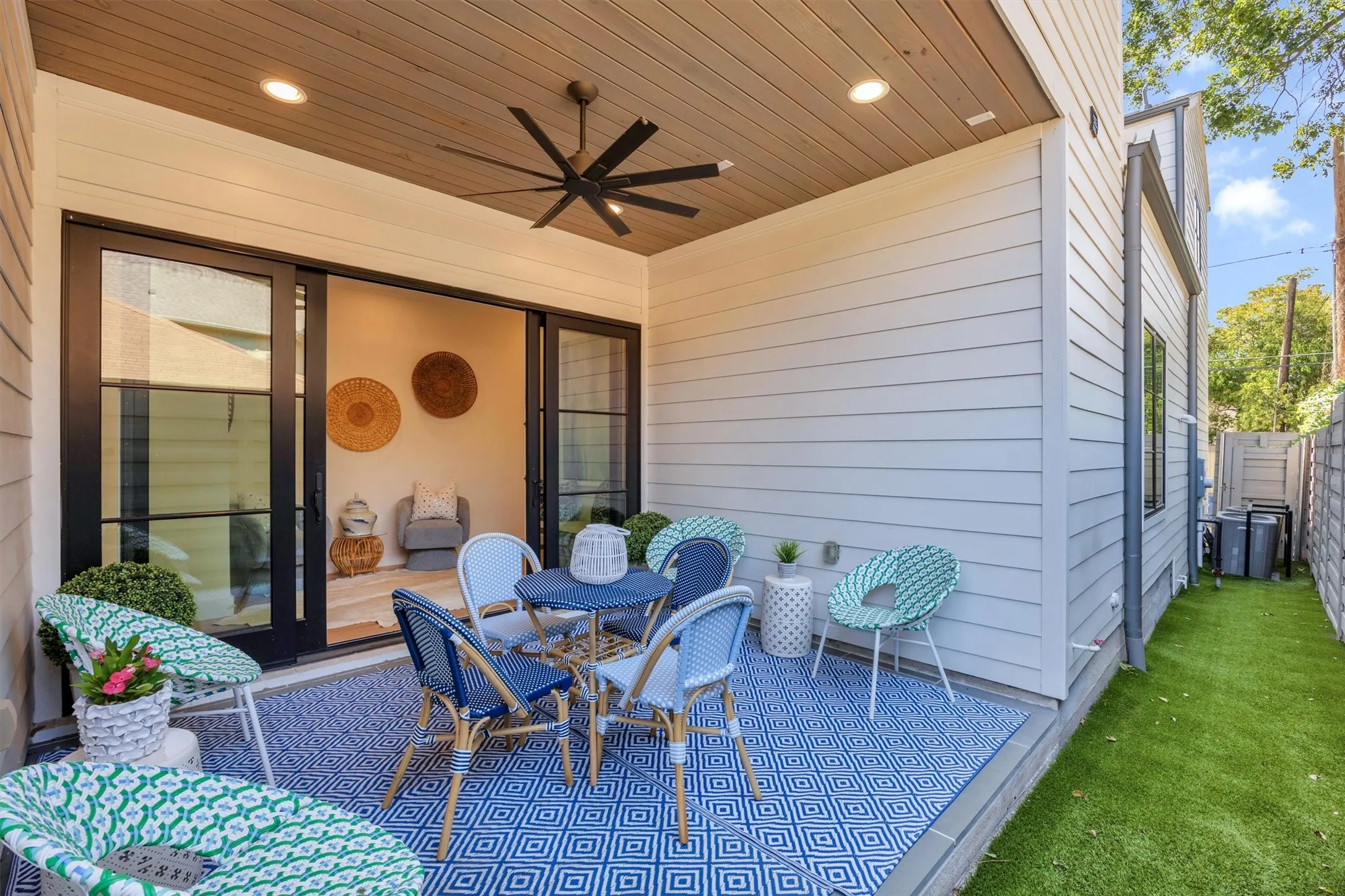 There is turf in the side area near the patio. This outdoor sitting area with sliding doors opening to another intimate conversation nook just inside will be great for football season!