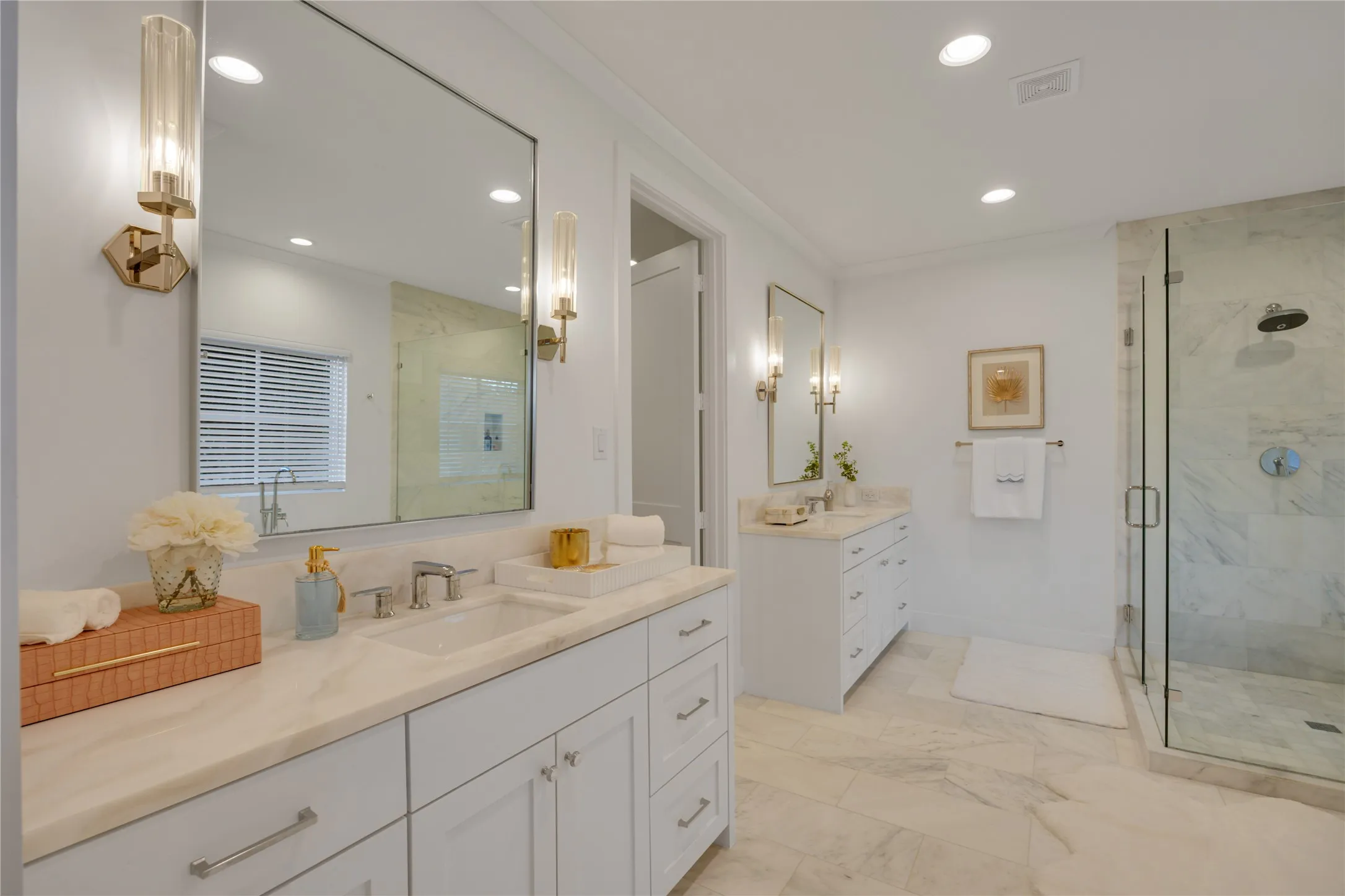 Huge and fabulous primary bathroom with natural marble throughout, features dual separate sink vanities, a huge marble shower, a water closet, and a huge walk-in closet.