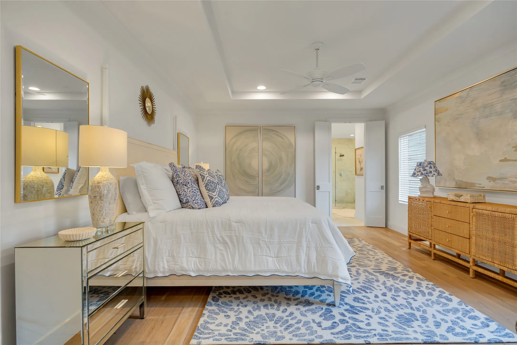 This spacious primary bedroom!  (This is a king sized bed and has two large nightstands with room to spare). You can see the entrance to the primary marble bath as well.