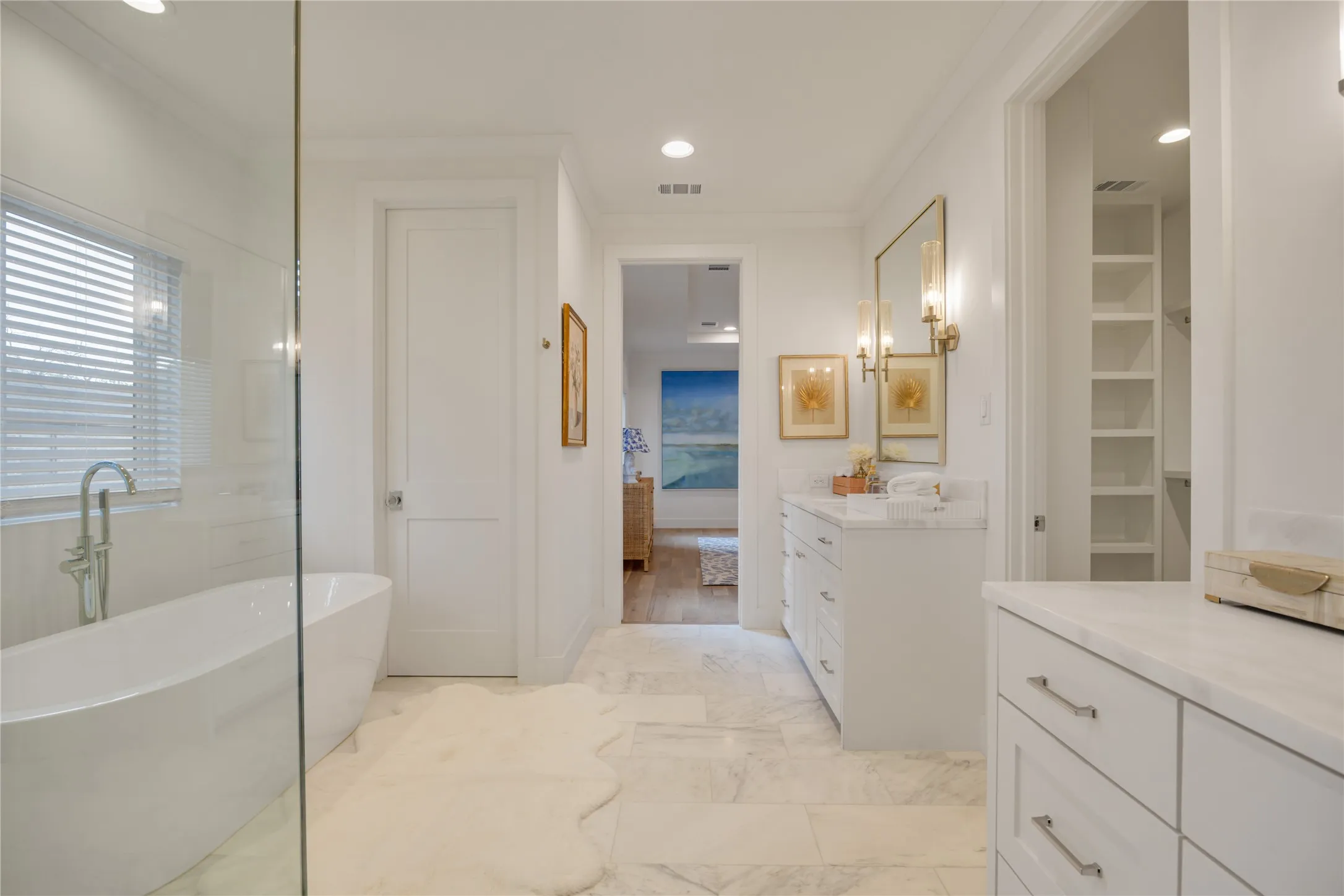 A great free standing soaking tub and separate marble shower with frameless glass.