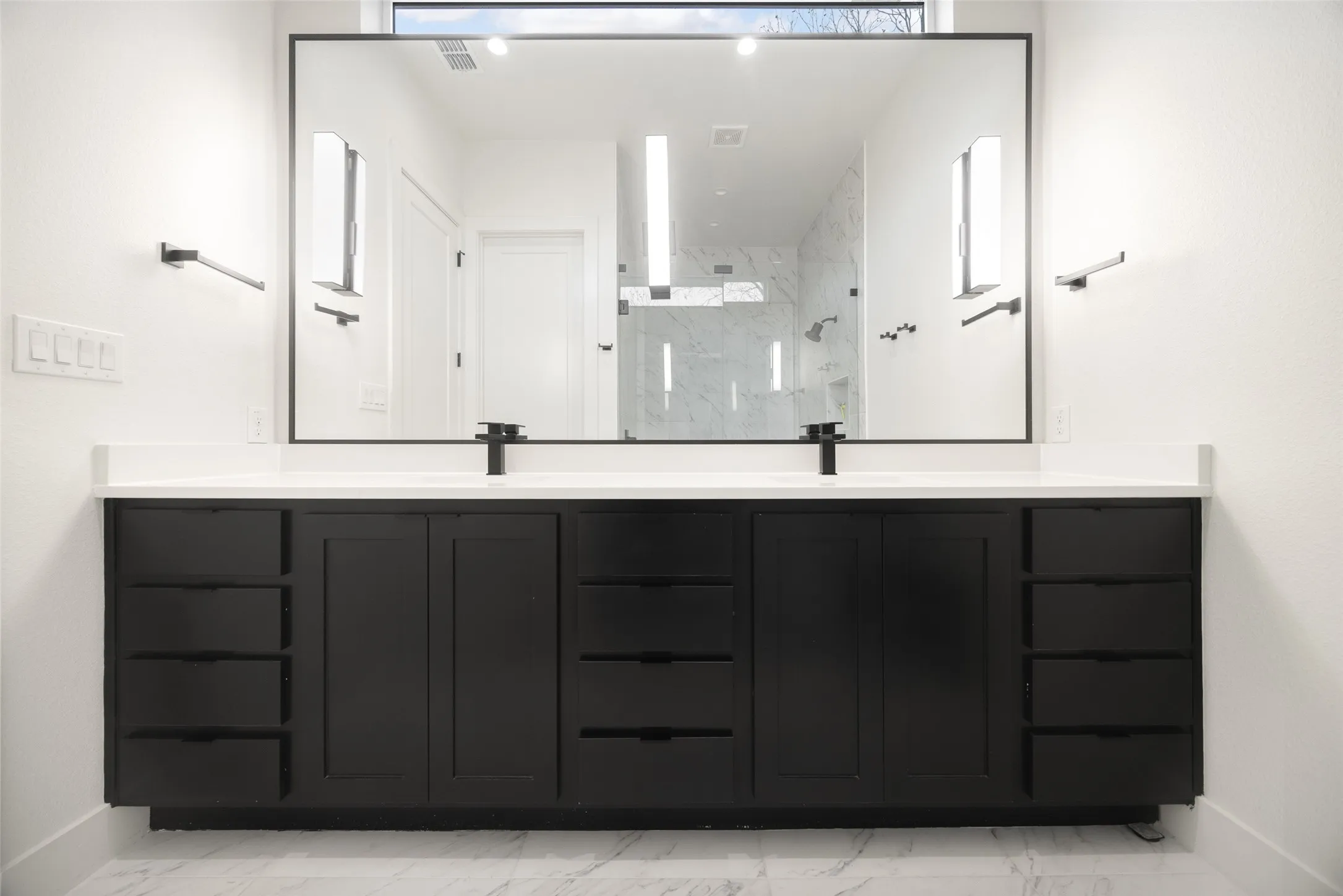 Primary double vanity, walk in closet, modern shower and soaking tub