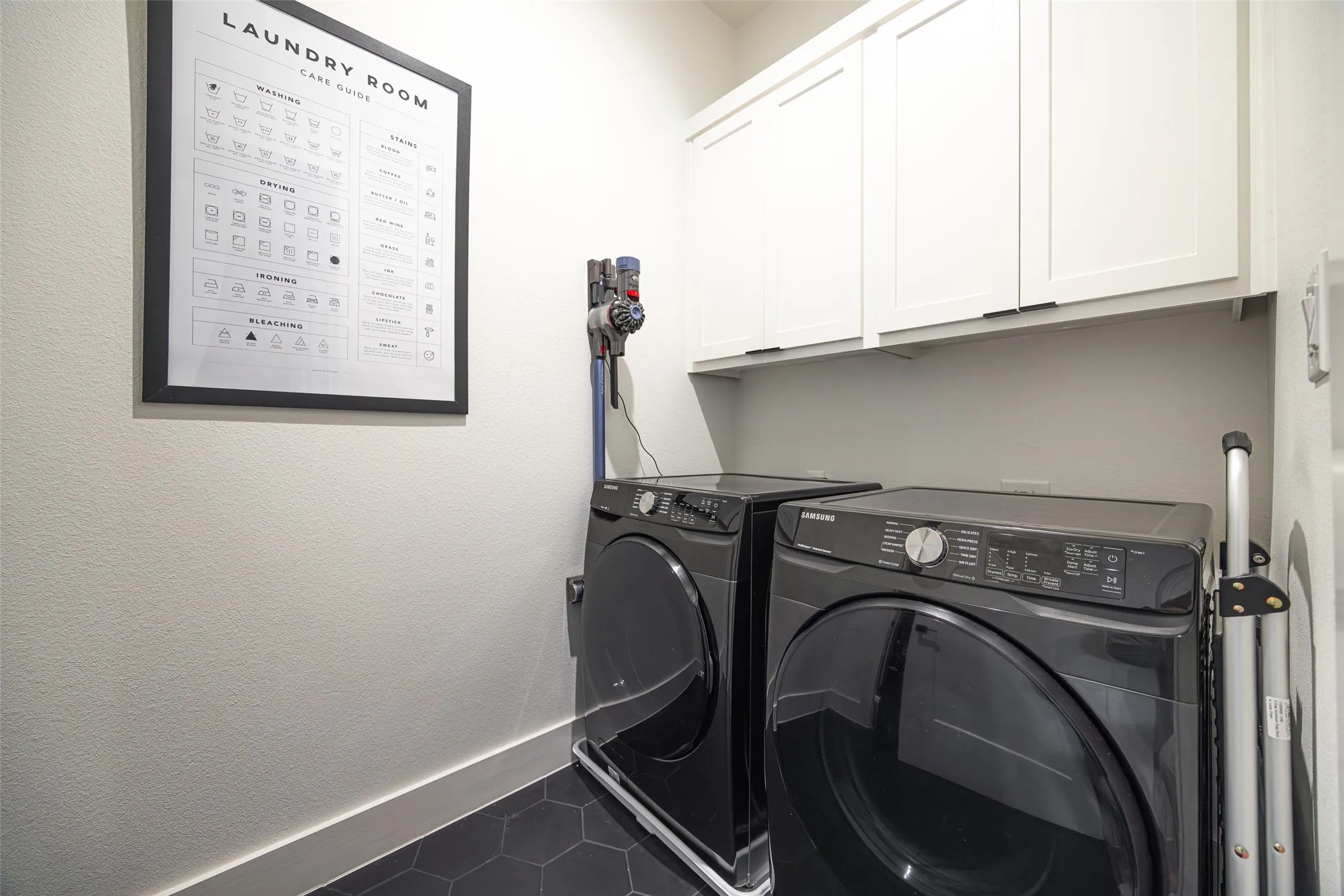 Full size laundry, built in cabinets and plenty of storage shelves opposite wall