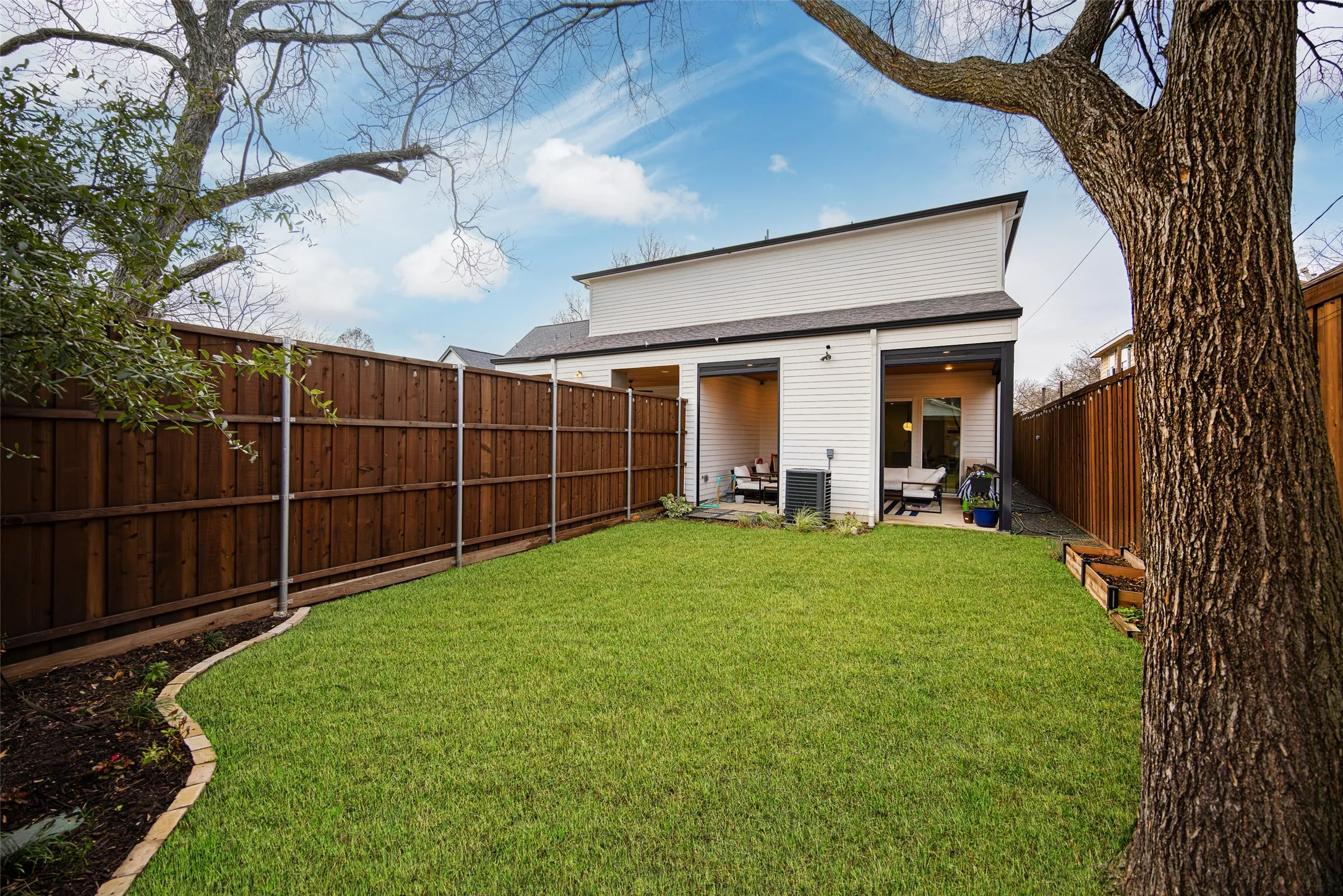 View of private yard, privacy fence and full covered patio