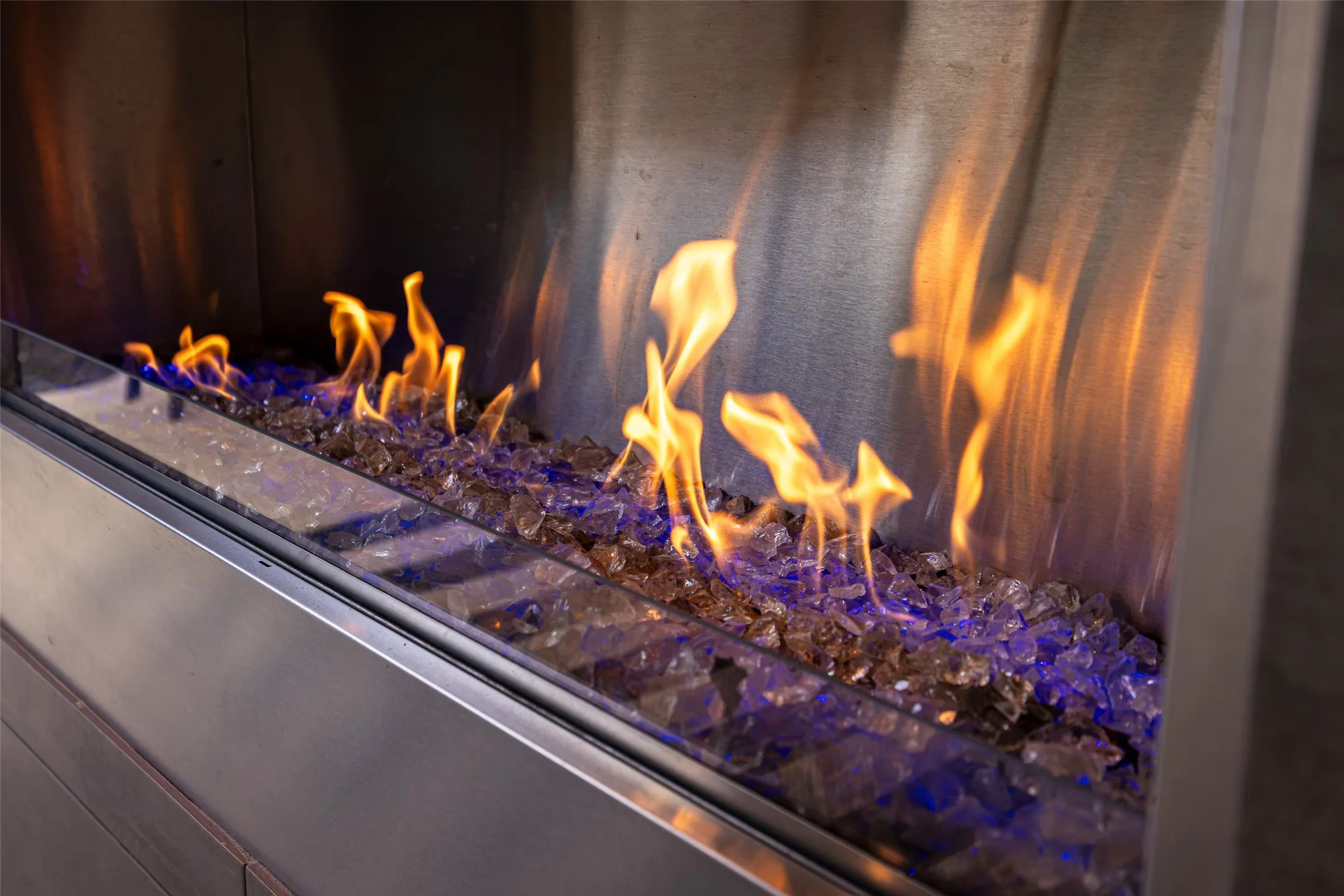 Feel the warmth.. cozy up and enjoy a modern backyard patio fireplace