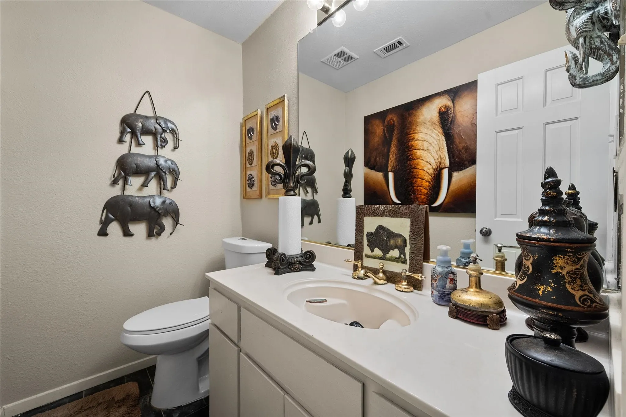 Single vanity with a light-colored countertop and integrated sink