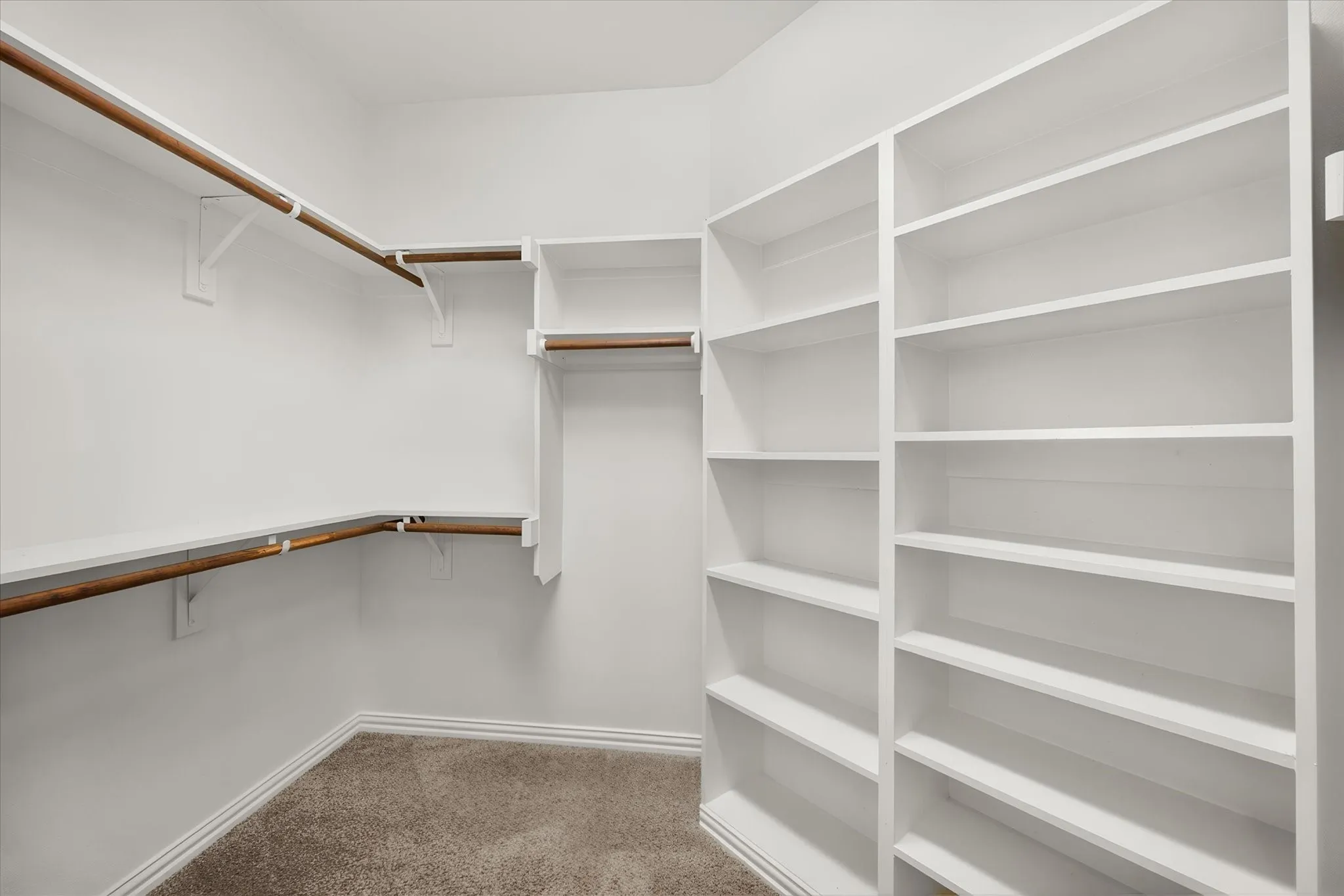 Primary closet has built in shelving for organizational space.