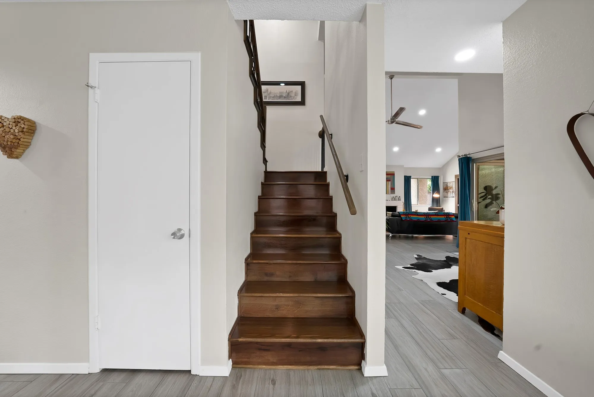 Staircase — Wood staircase with iron balusters and wood handrail, leading to second floor loft area.