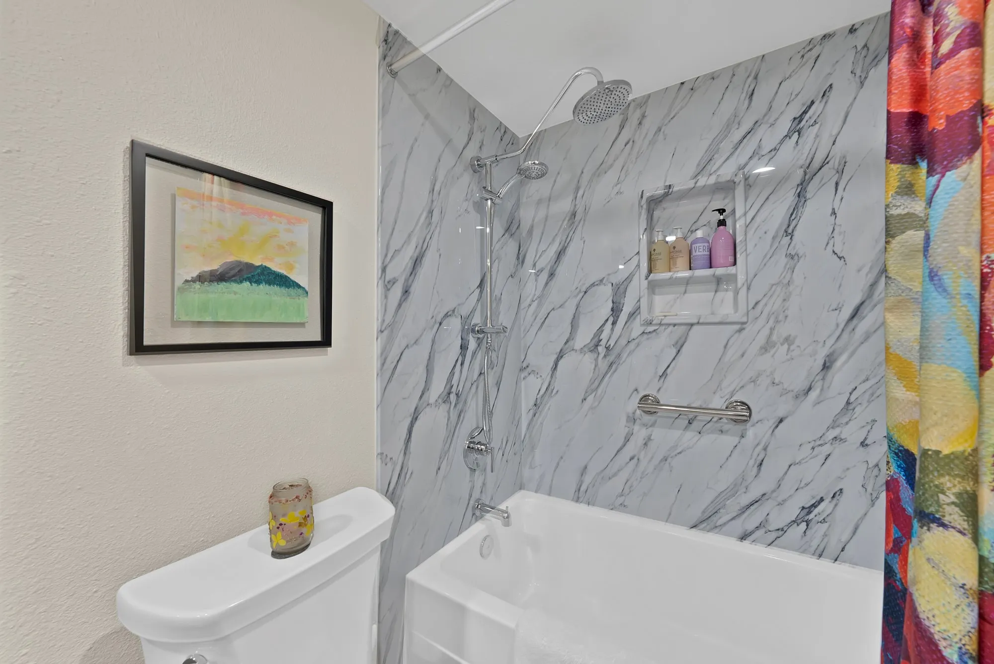 Primary bathroom — Dual vanity with blue solid surface countertop and dark wood cabinetry, with view through to adjoining bedroom.