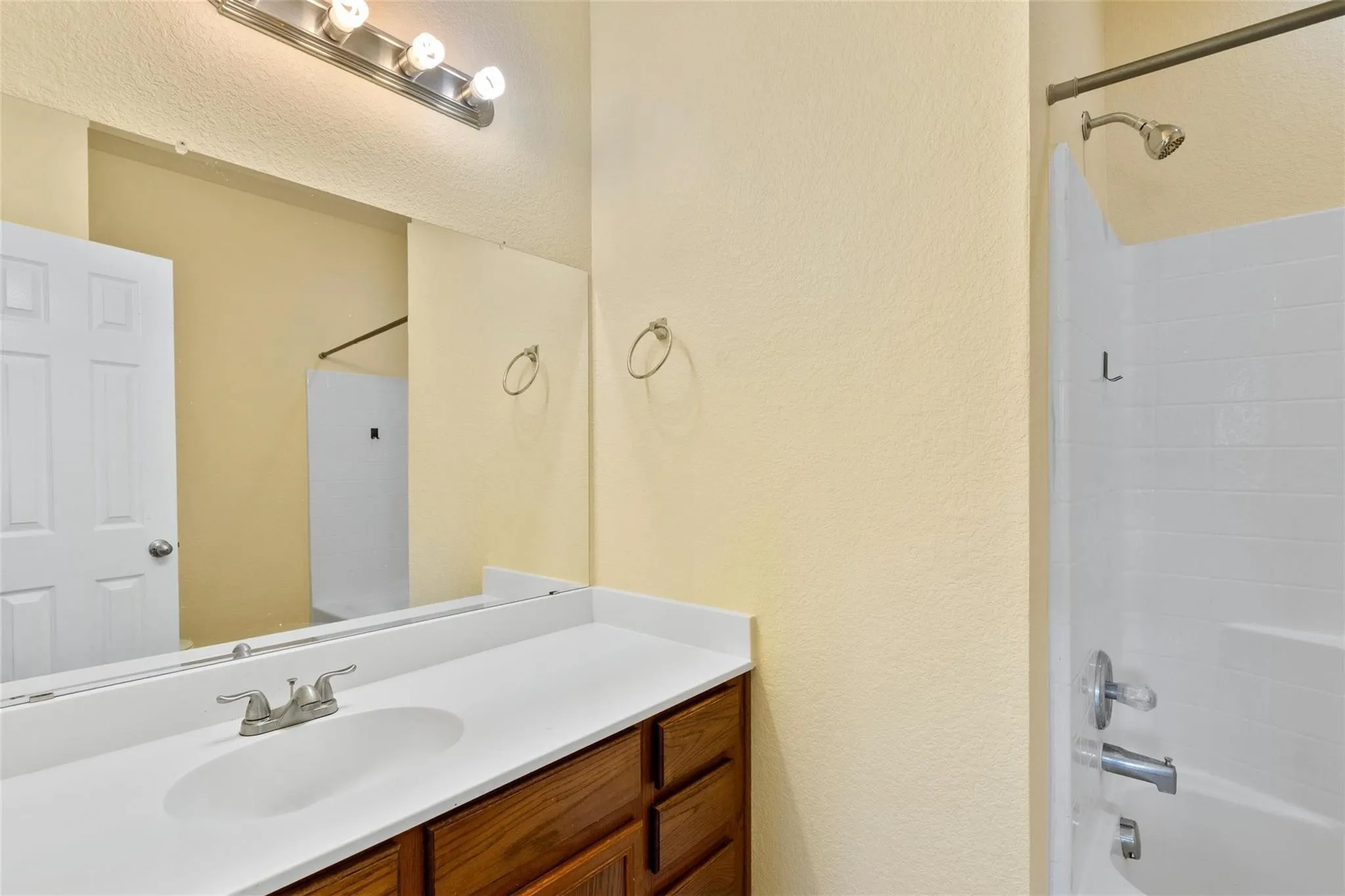White countertop with an integrated sink and brushed nickel faucet