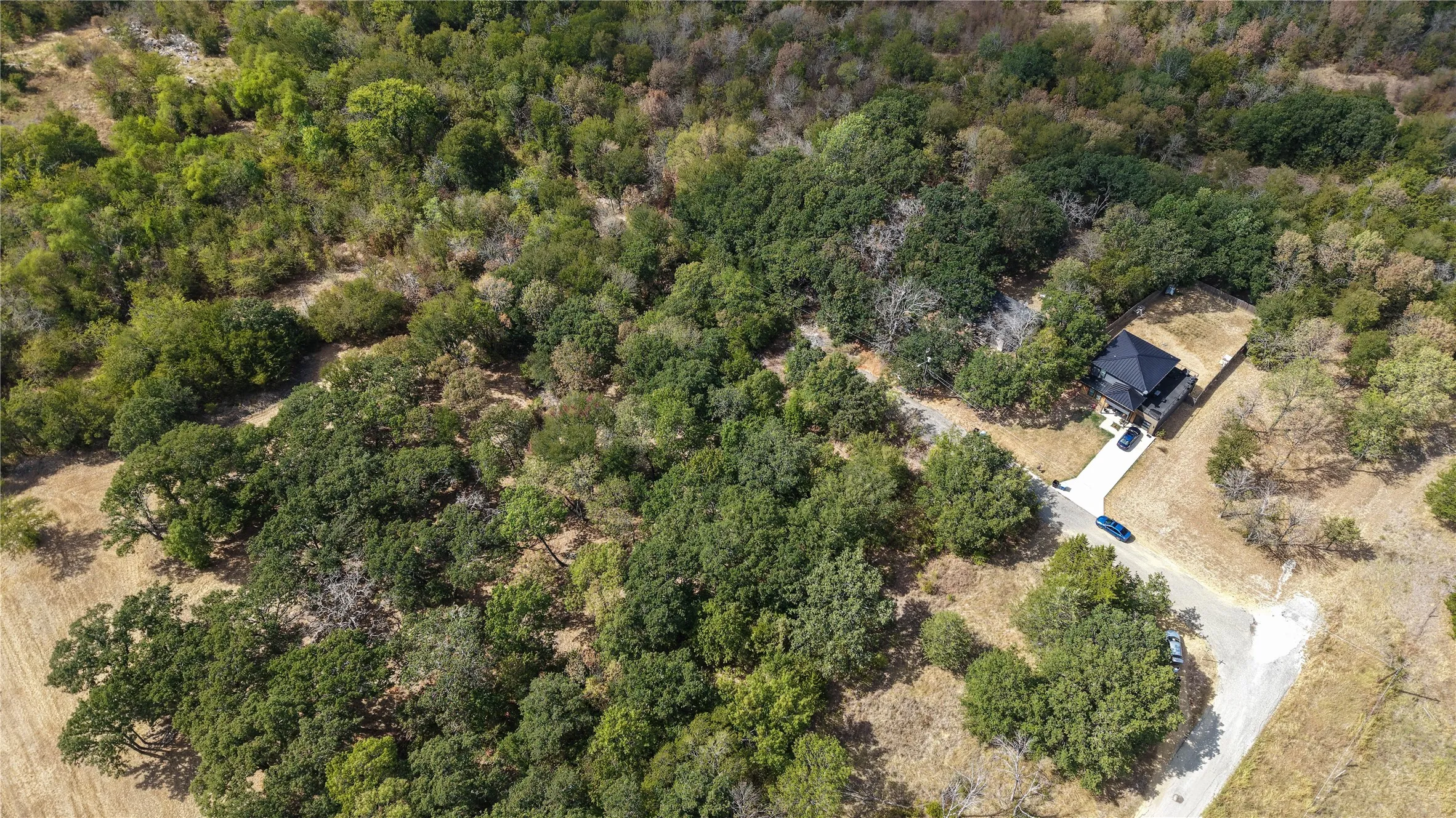 Property situated within a heavily wooded landscape