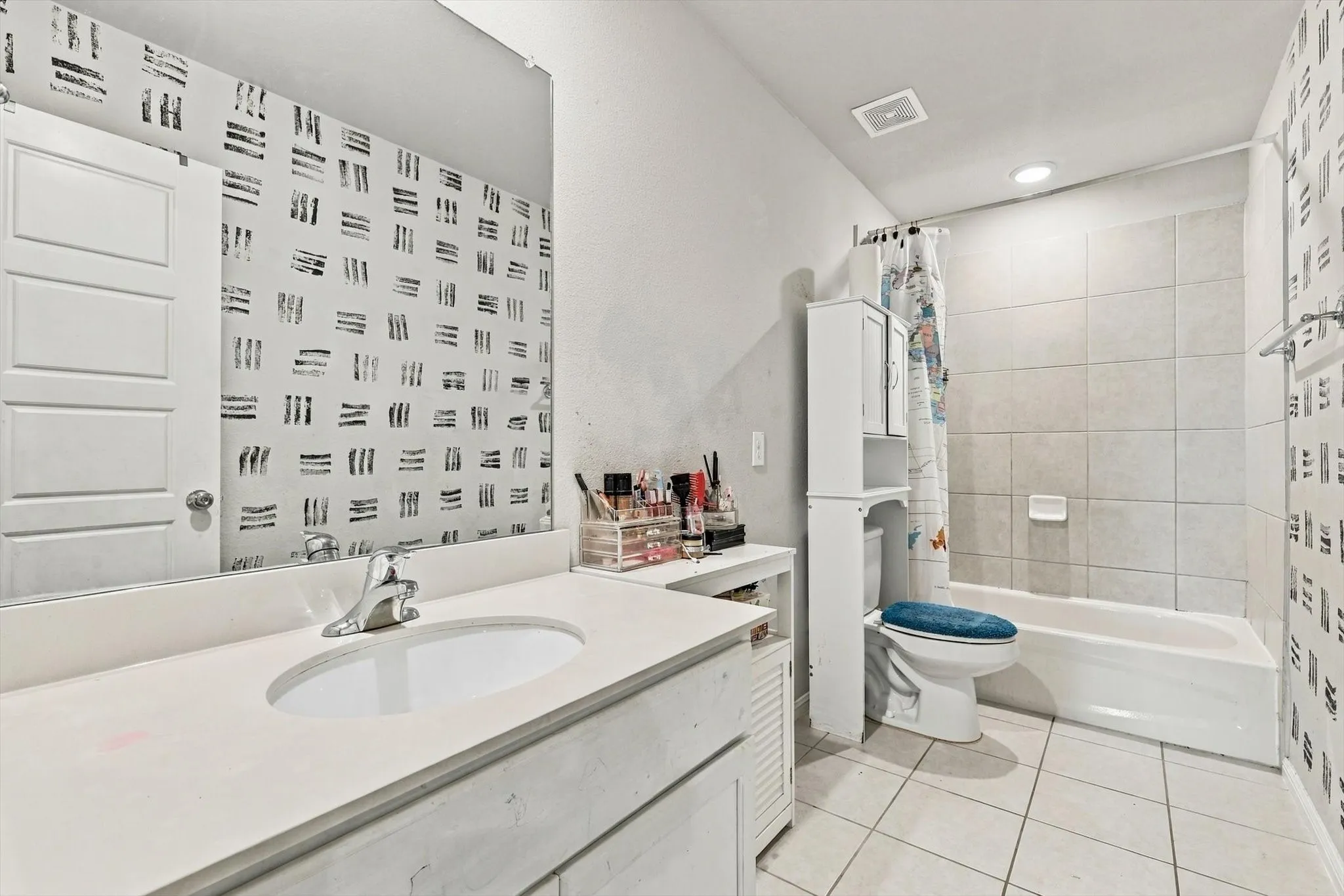 Vanity with integrated sink, chrome faucet, and expansive mirror