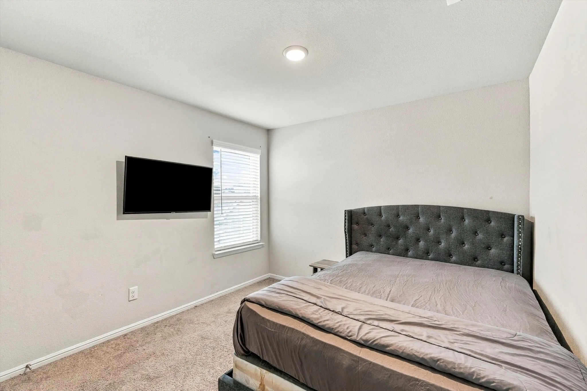 Recessed ceiling lighting, light-toned wall paint, window with blinds, and neutral carpeting