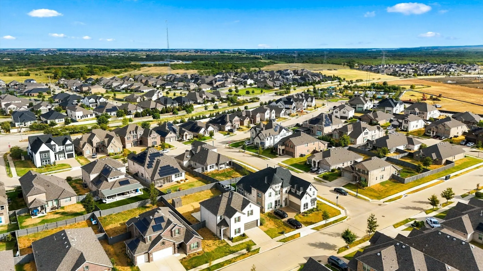 Residential development featuring various architectural styles, paved streets, and varied landscaping