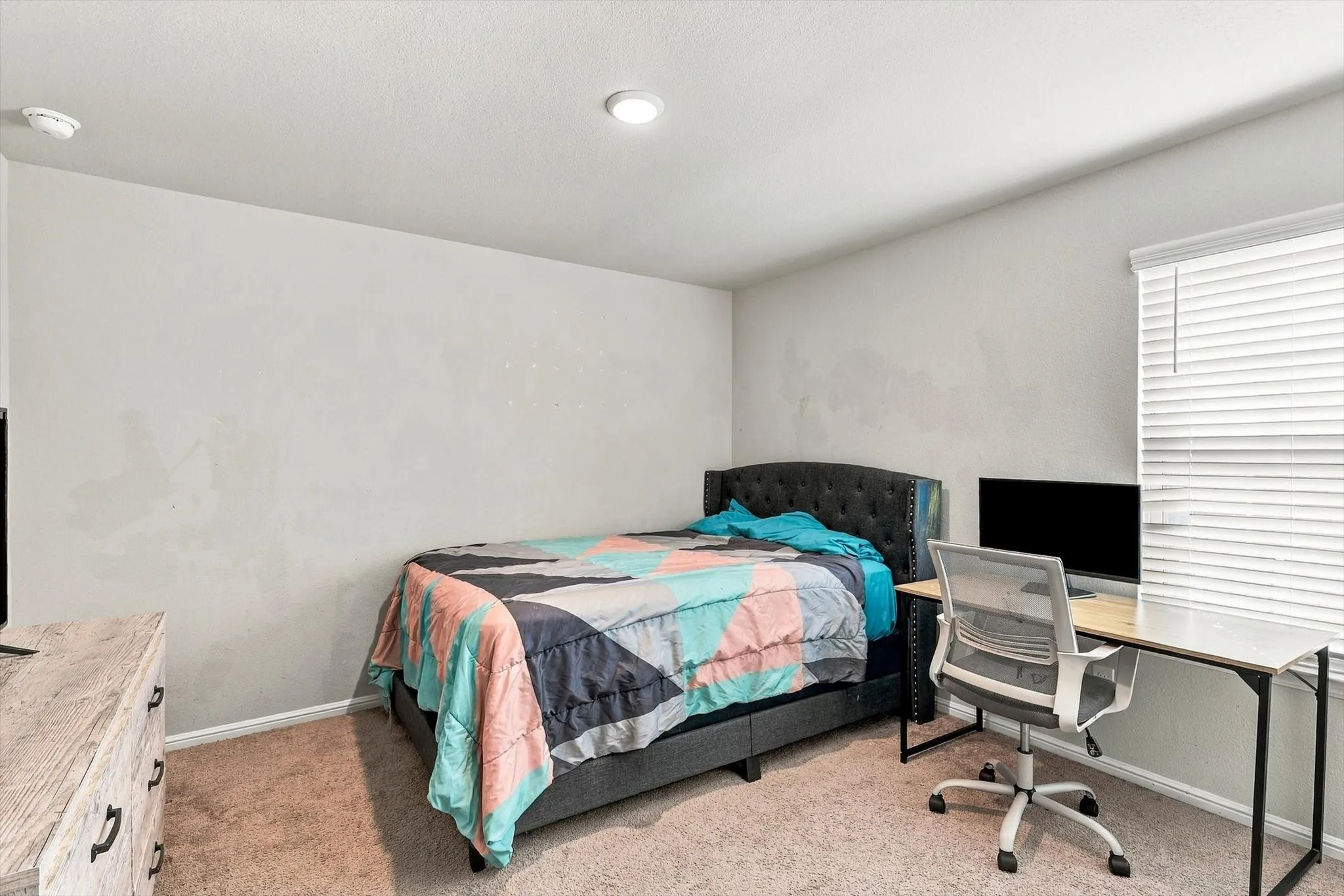 Recessed ceiling lighting, window with horizontal blinds, and carpeted flooring